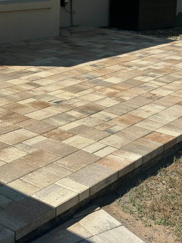 Brick paver patio in various tan and brown tones.