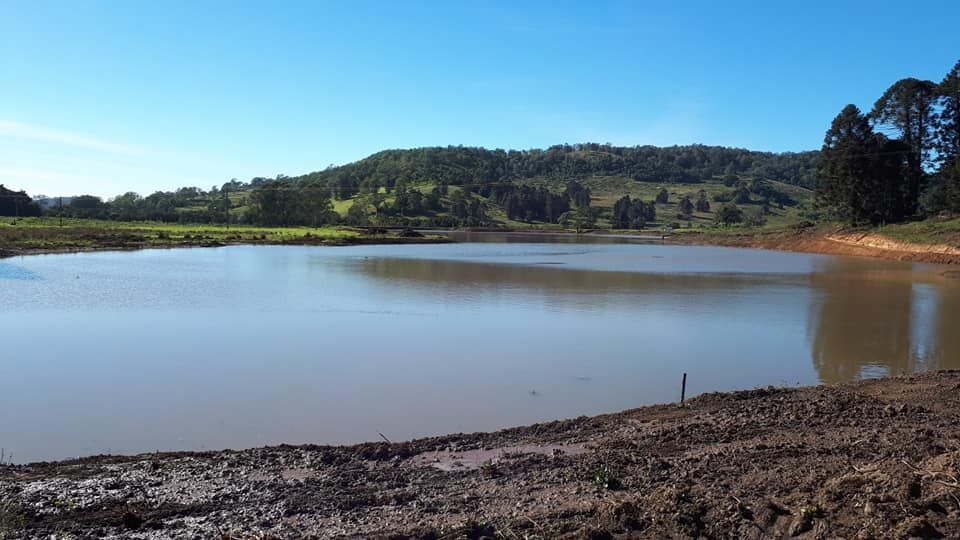 A Large Body Of Water Surrounded By Trees And Dirt — Dams Cleaned in Mudjimba, QLD