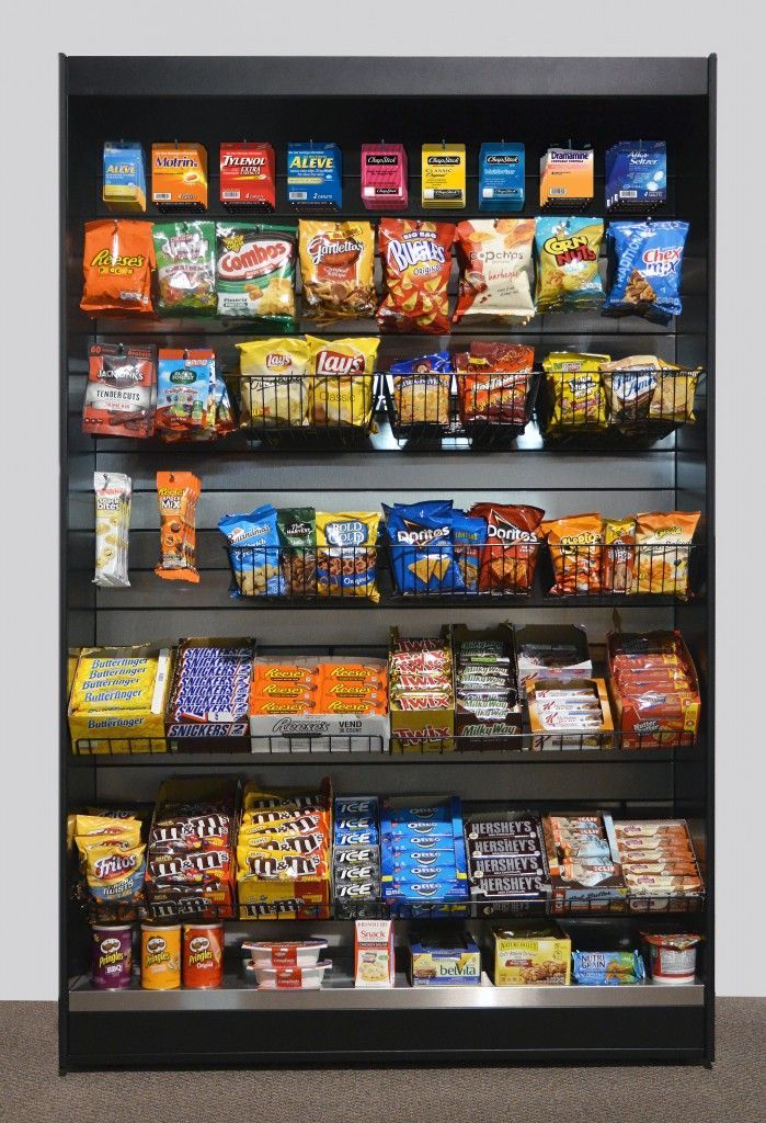 a store shelf filled with snacks and candy including m & m 's