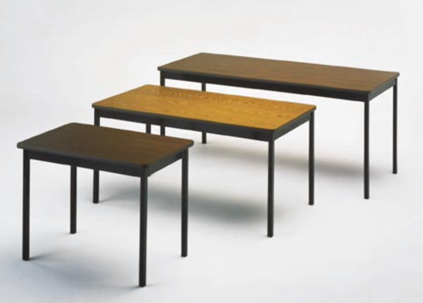 Three wooden tables with metal legs on a white background