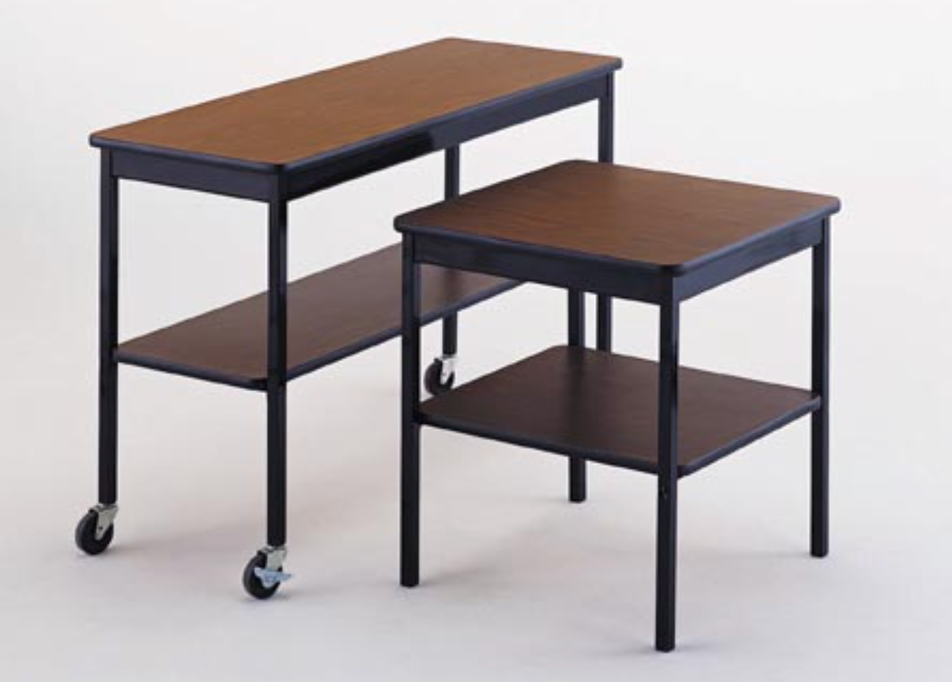 Two wooden tables with wheels and shelves on a white background