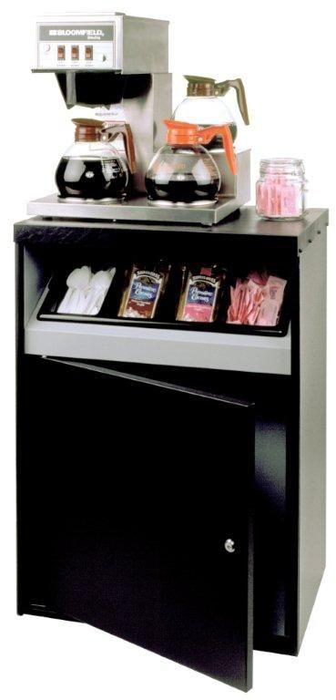 A coffee maker is sitting on top of a black cabinet.