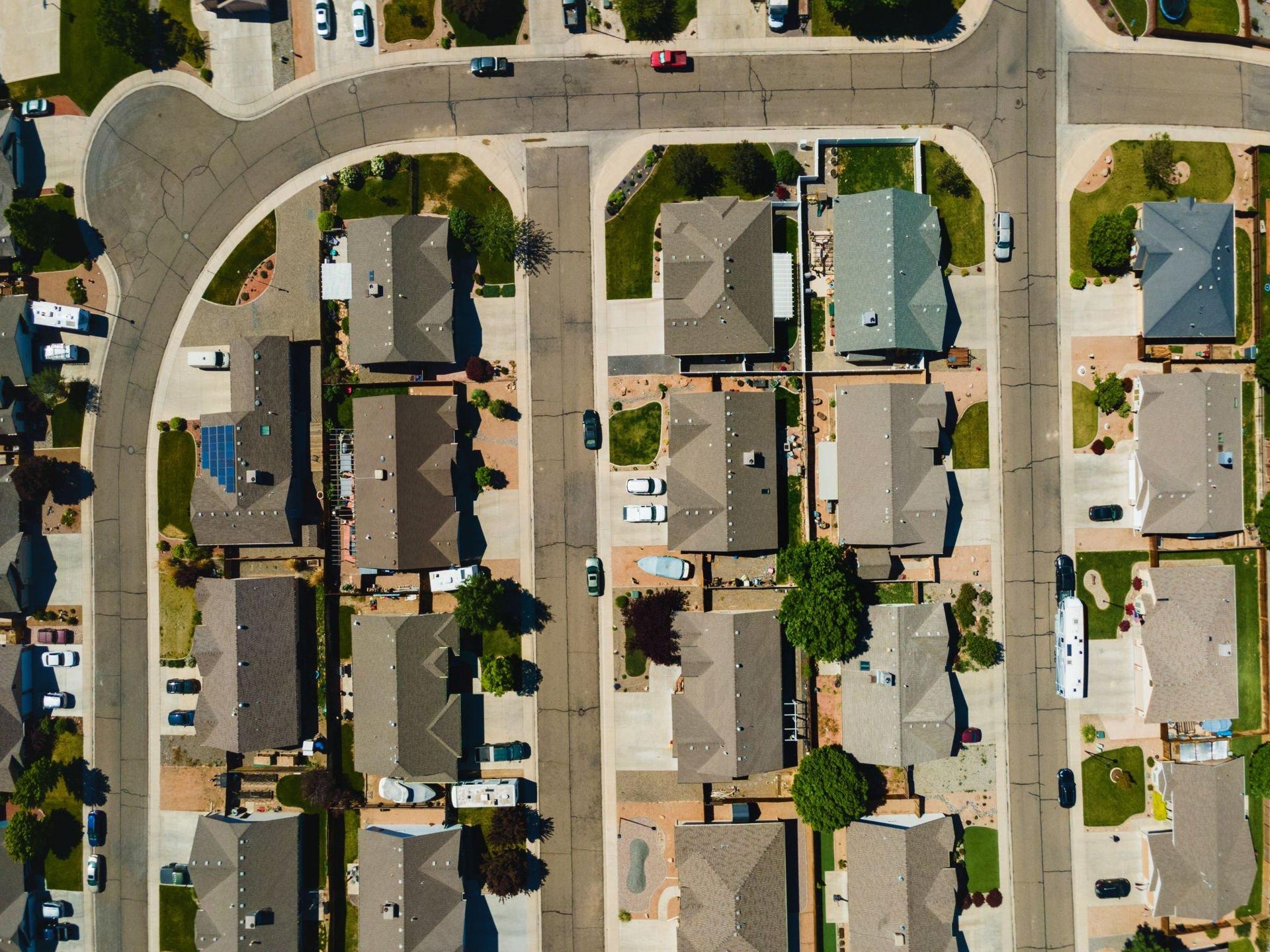 An aerial view of a residential neighborhood with lots of houses and streets.