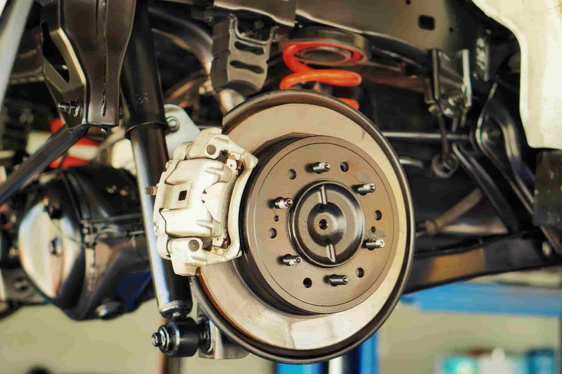 A Close Up of a Car 's Brake System on a Lift — Quick Fix Automotive in Ballina, NSW
