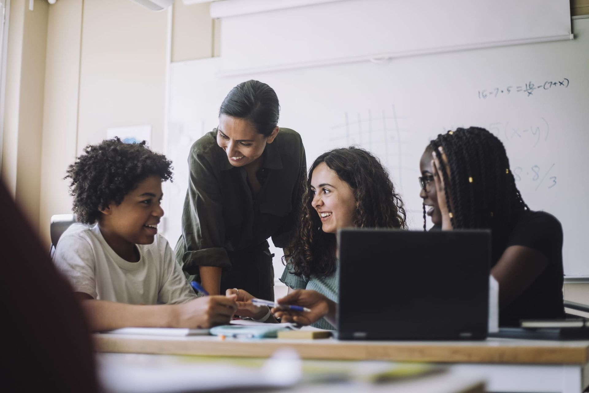 A teacher is teaching a group of students in a classroom.