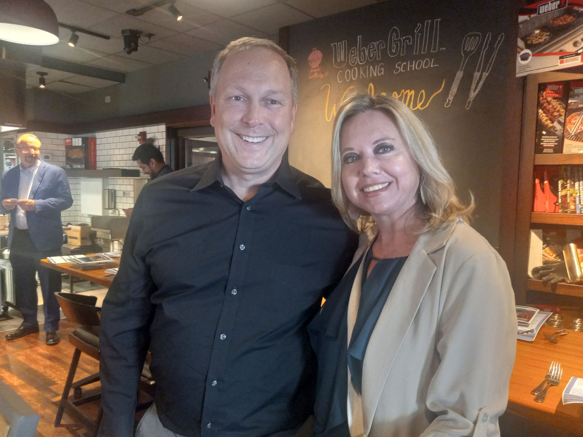 A man and a woman are posing for a picture in a restaurant.