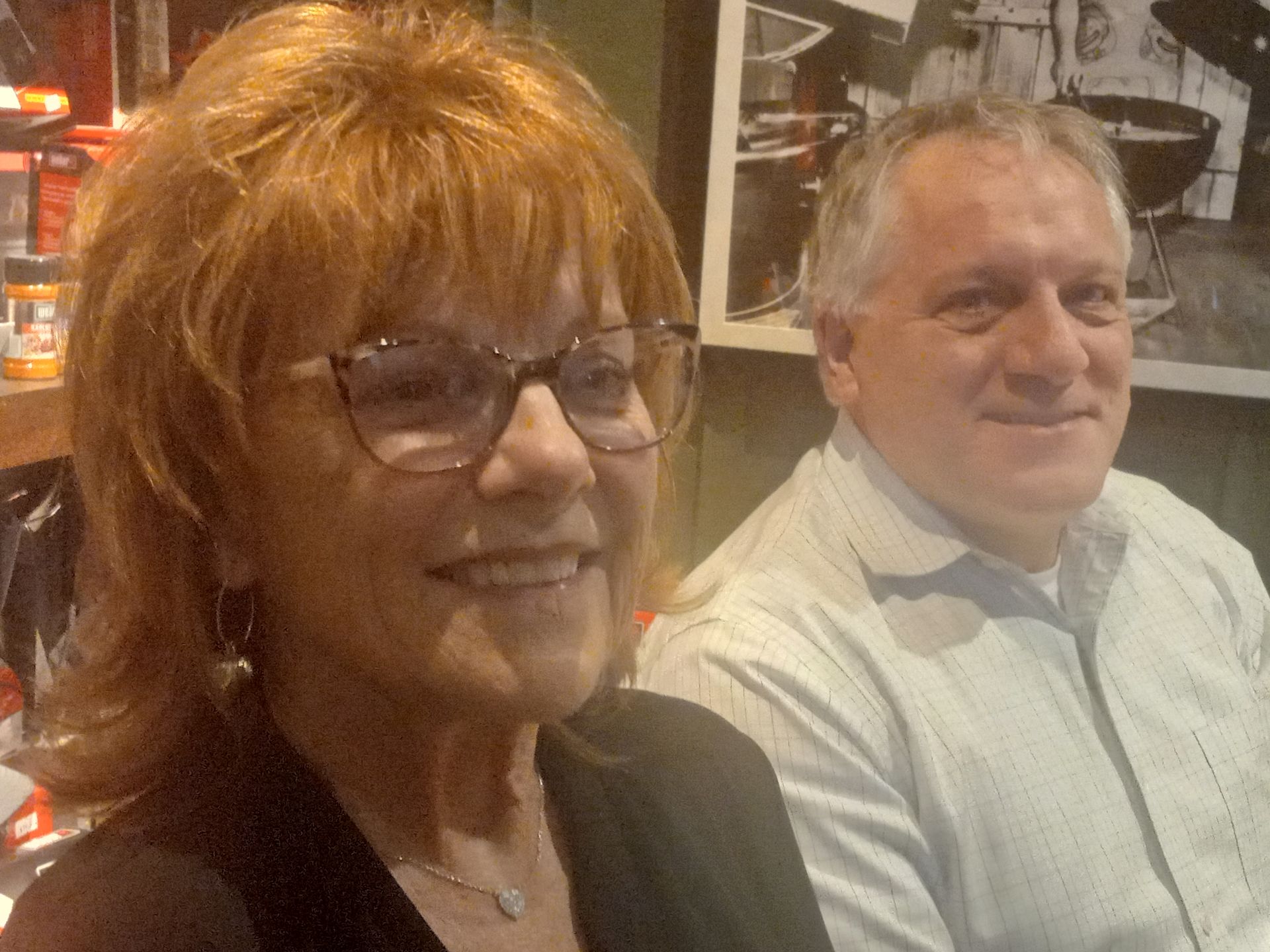 A man and a woman are sitting next to each other and smiling