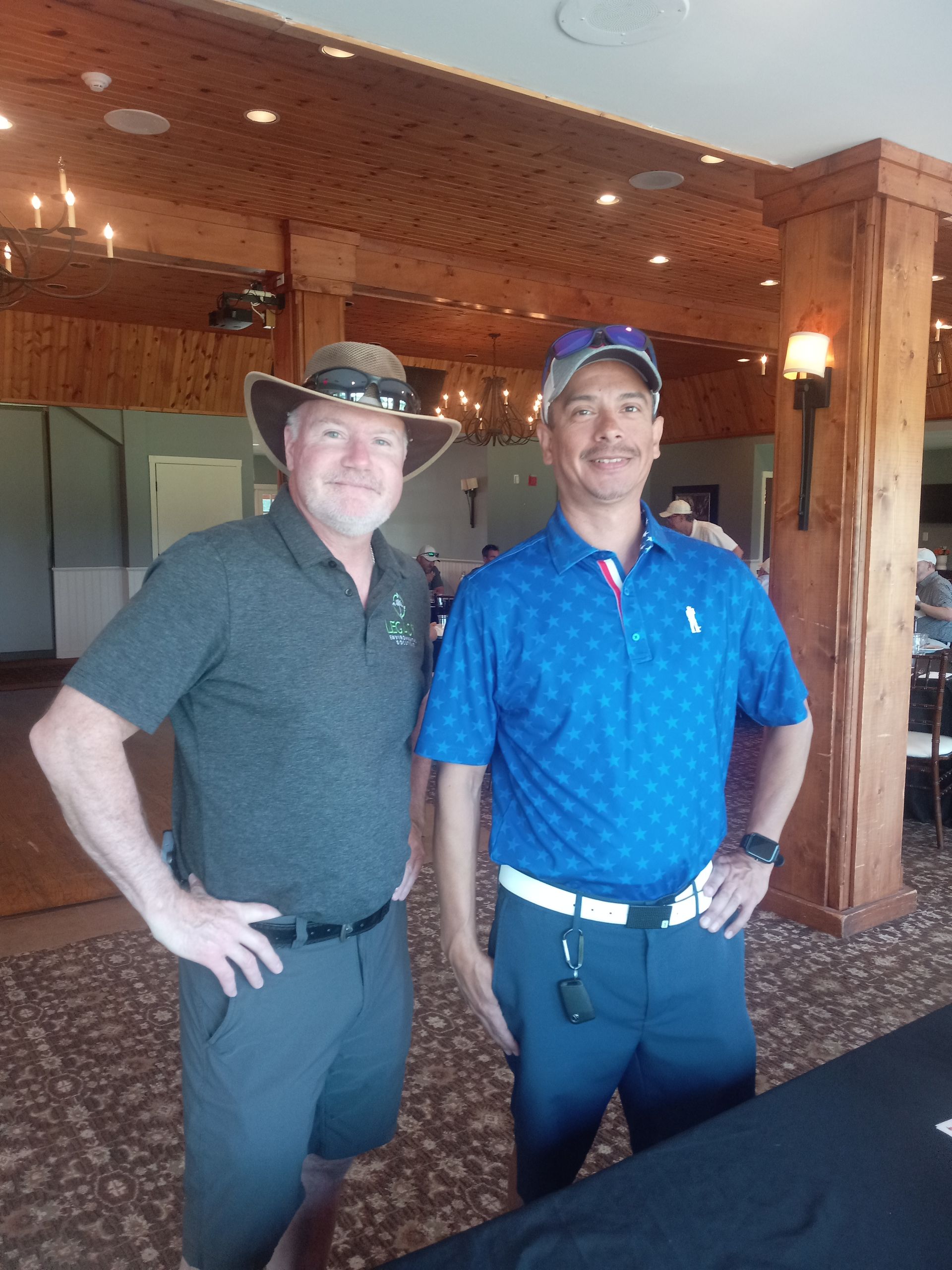 Two men standing next to each other in a room