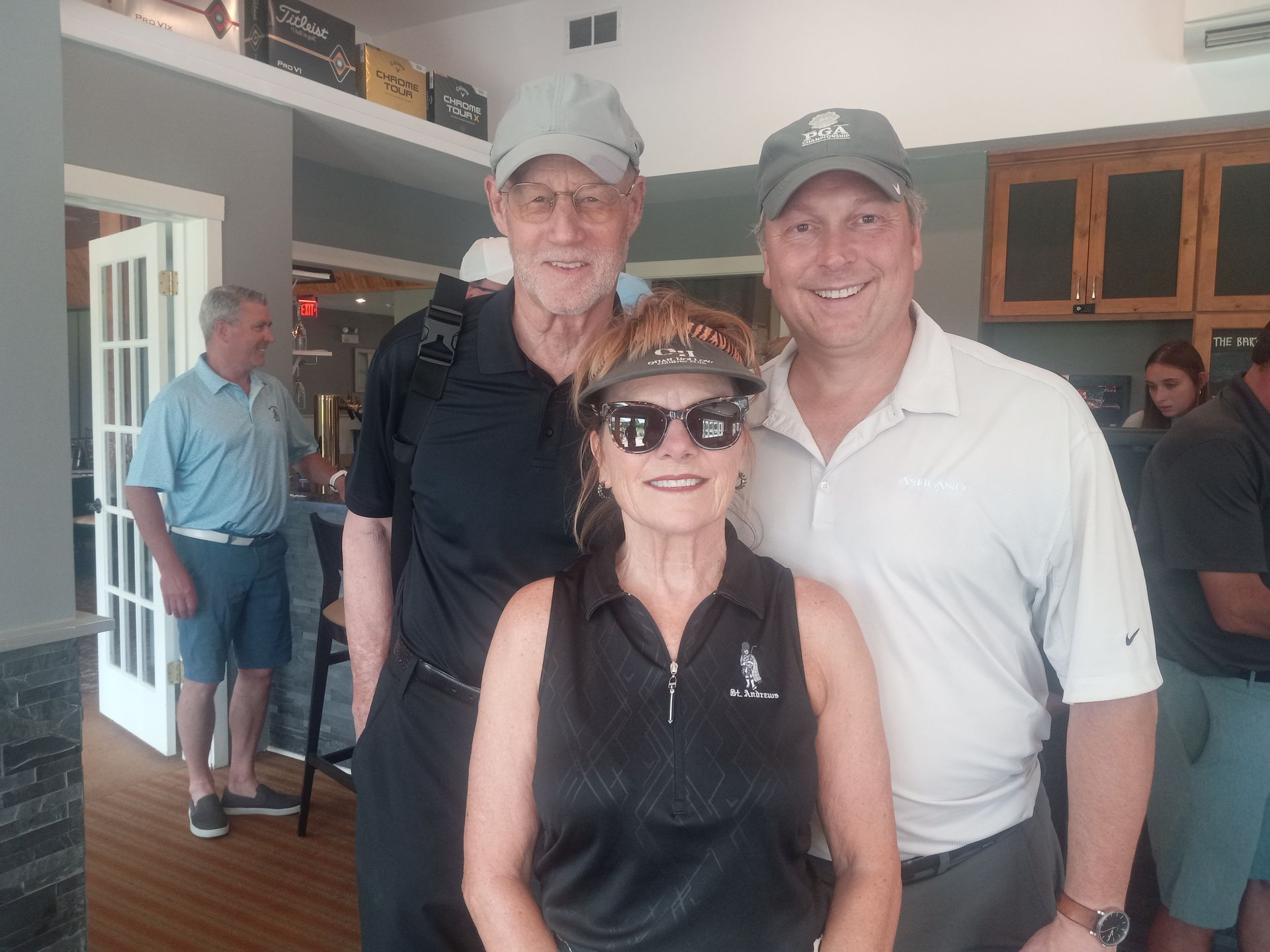 A group of people are posing for a picture in a room.
