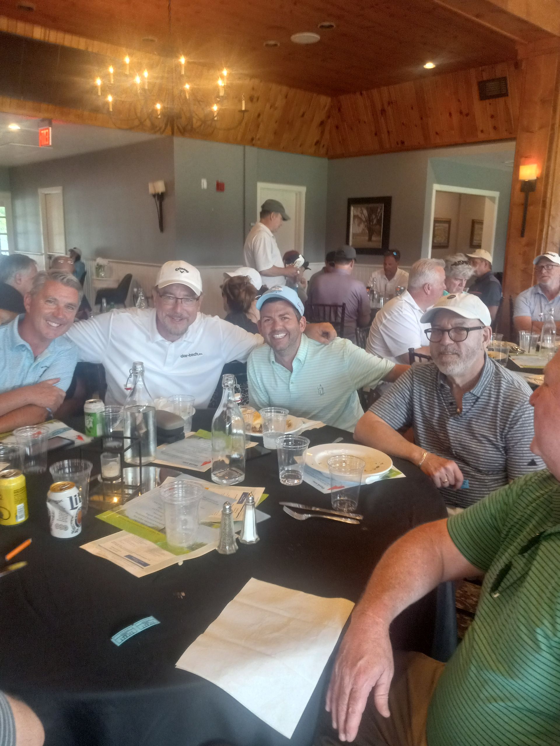 A group of men are sitting at a table in a restaurant.