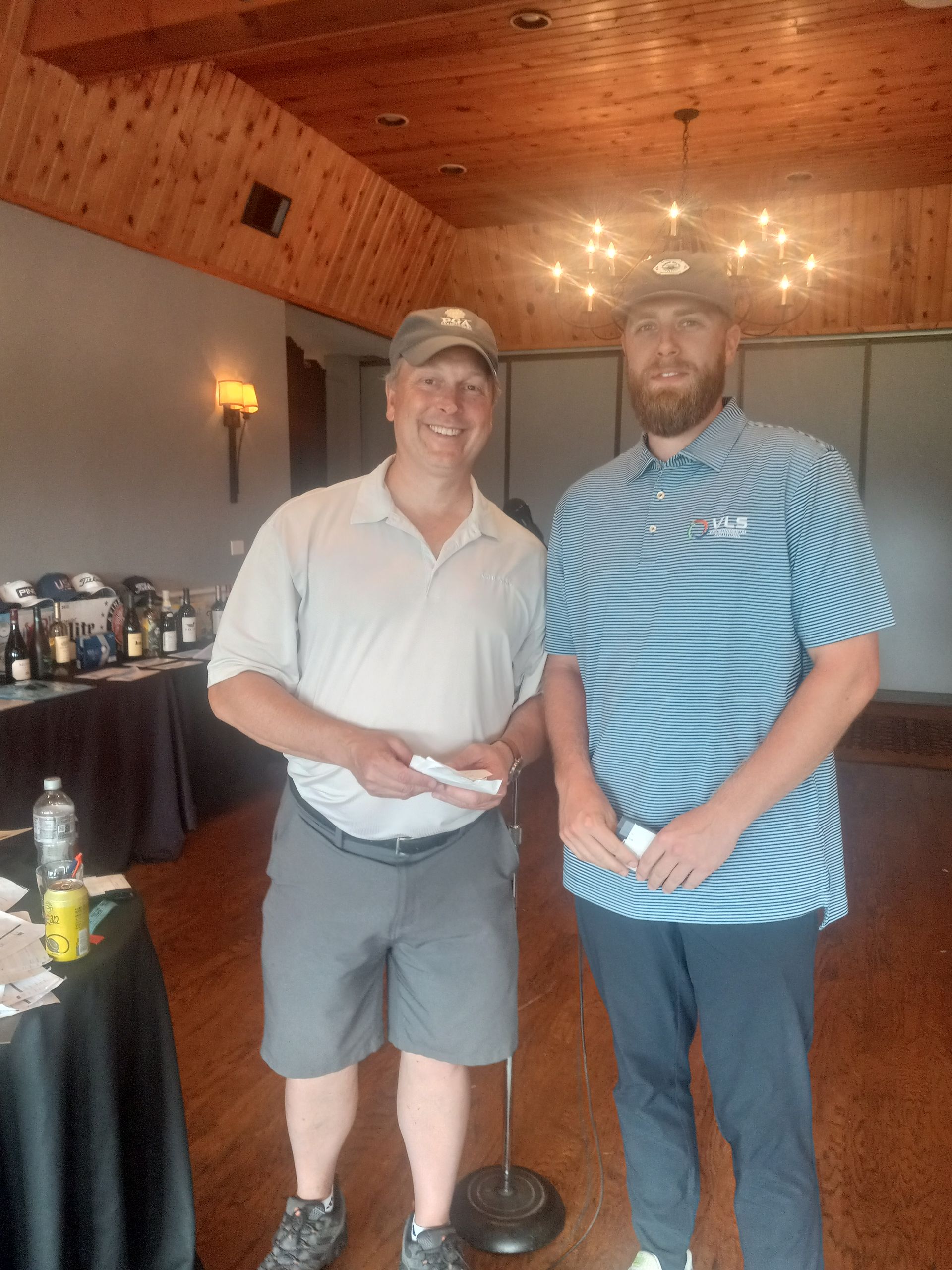 Two men are standing next to each other in a room.