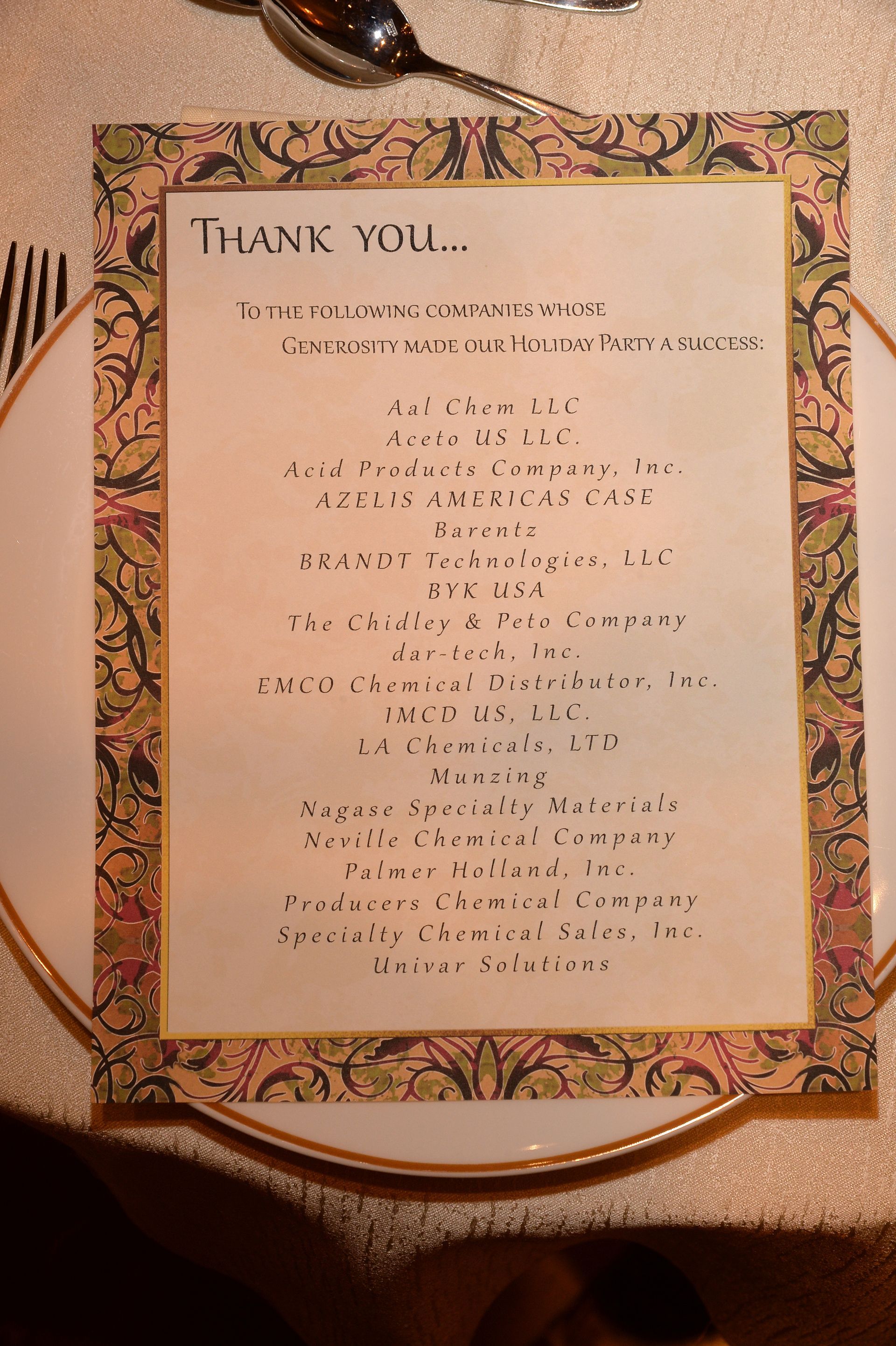 A thank you card is on a plate on a table.