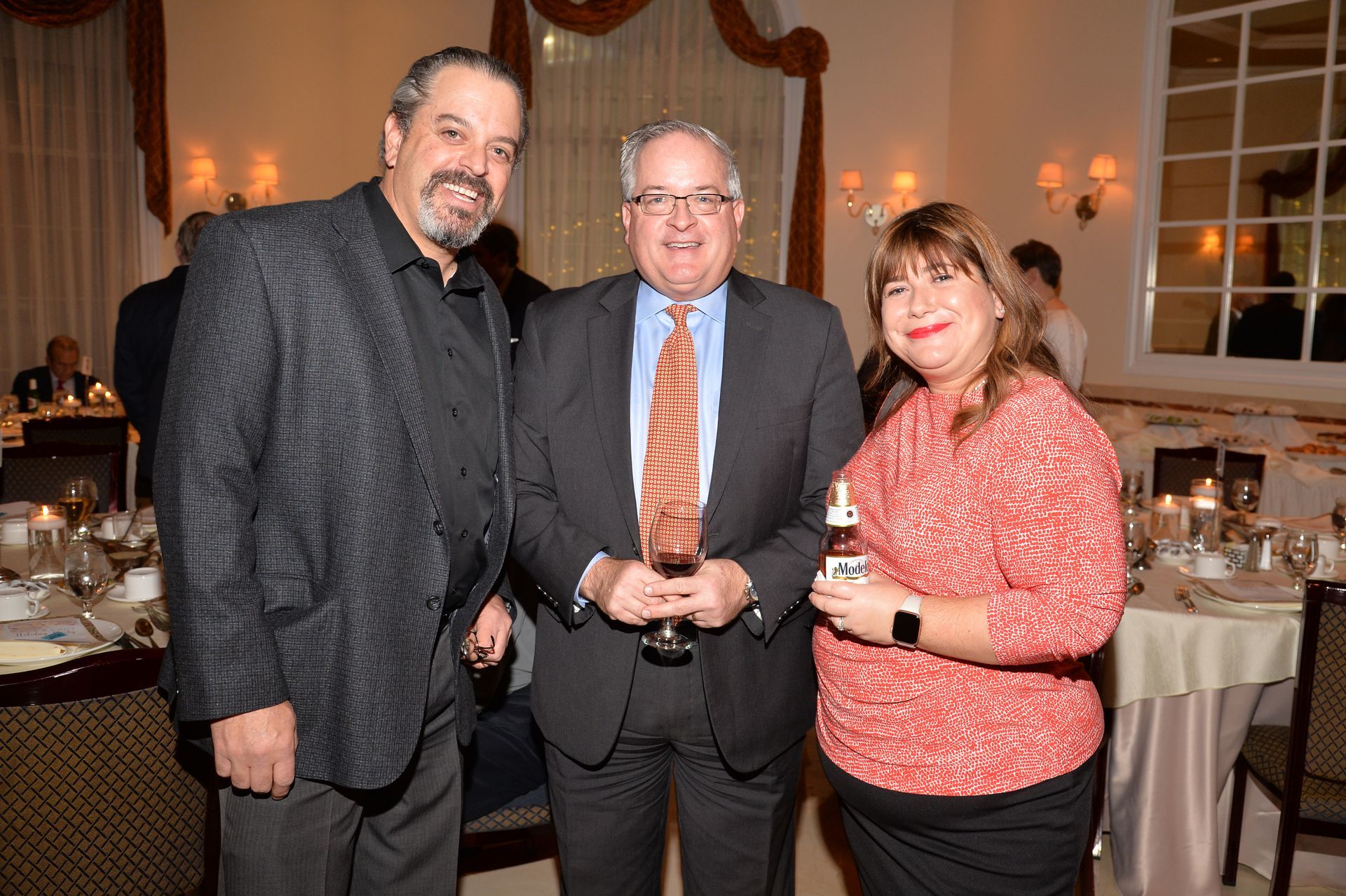 A group of people are standing next to each other in a room.