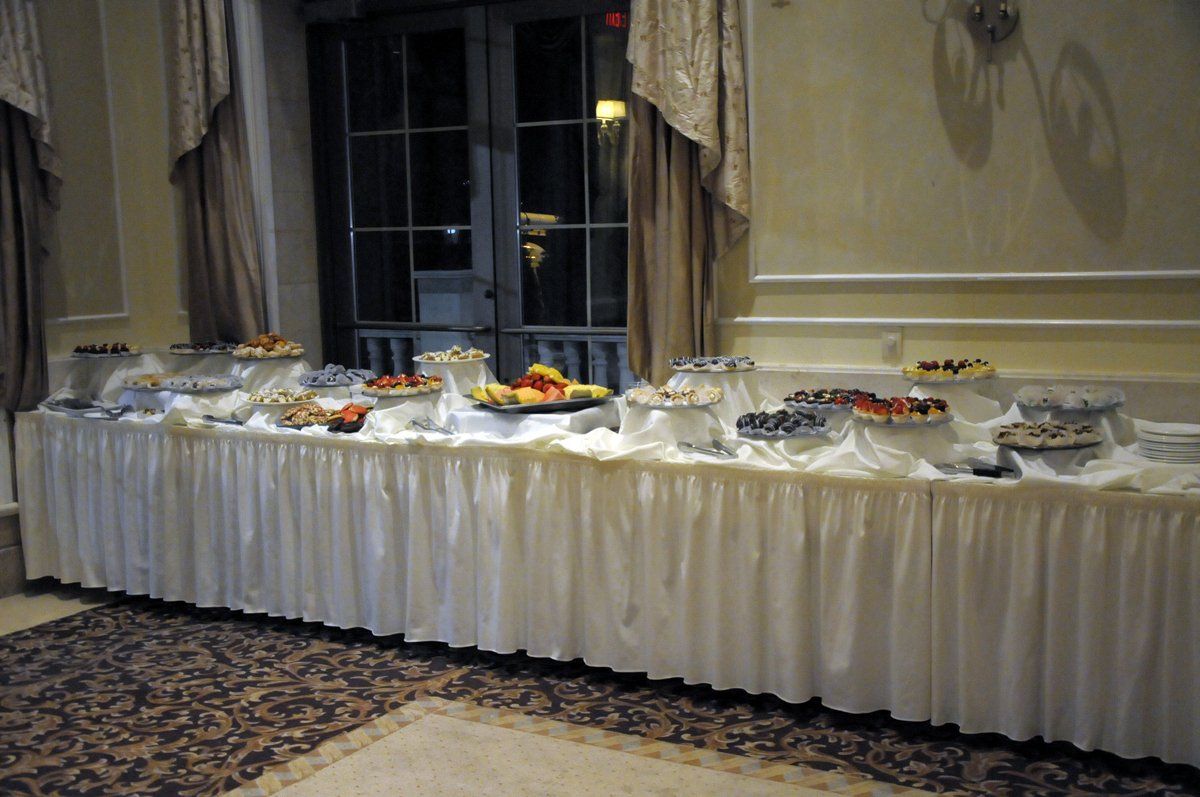 There is a long table with a lot of food on it.