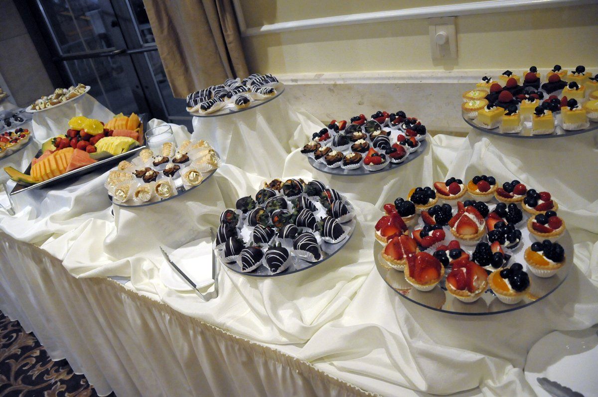 A table with a variety of desserts and fruit on it