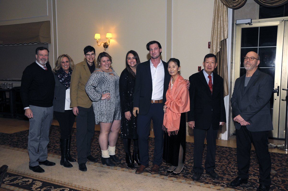 A group of people are posing for a picture in a room.