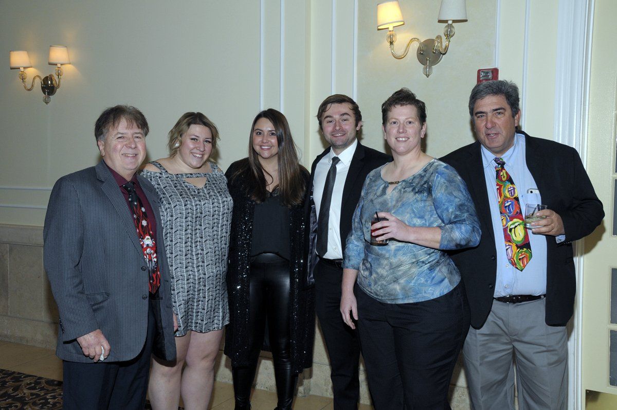 A group of people are posing for a picture in a room.