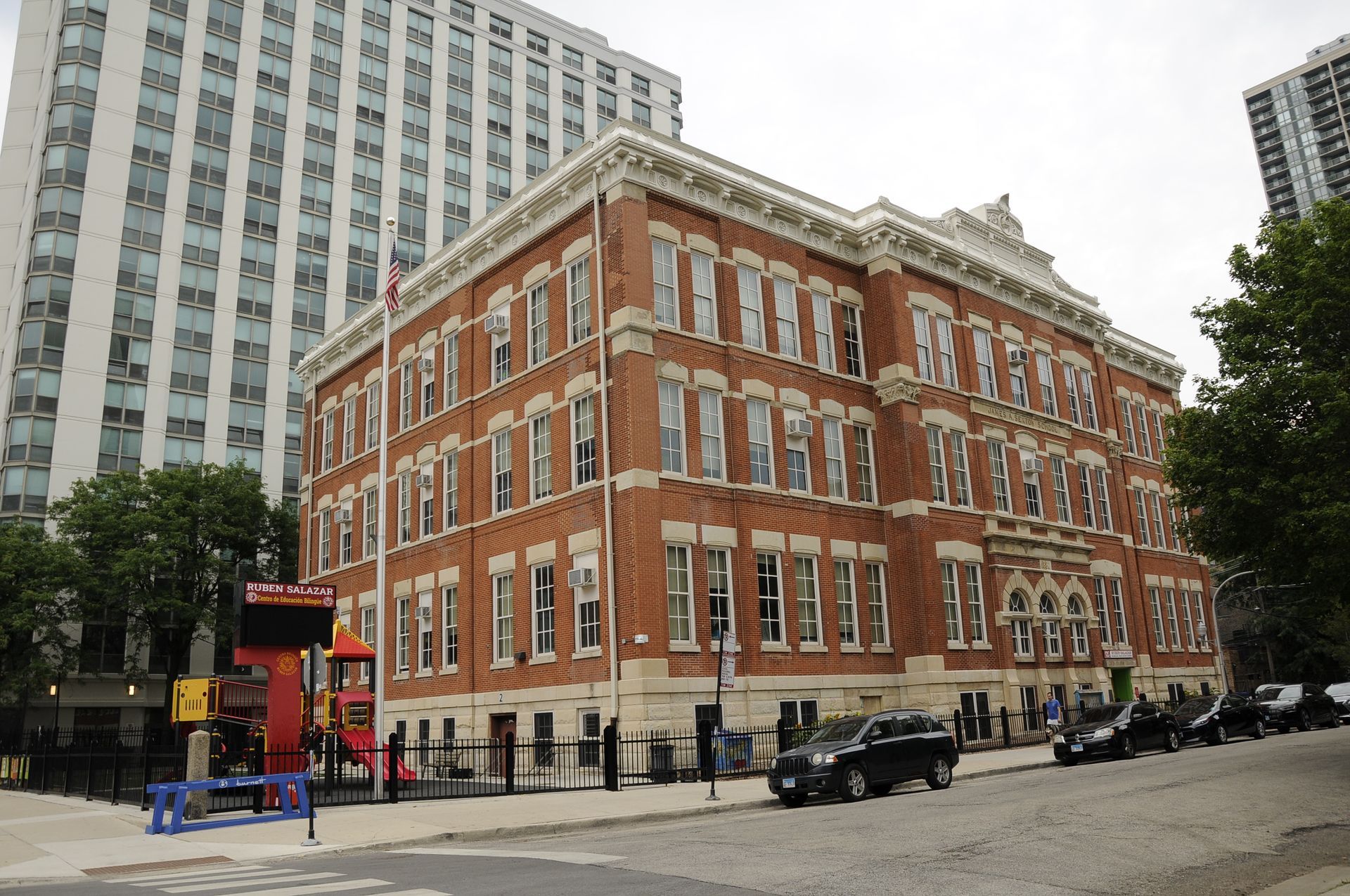 A large brick building with cars parked in front of it