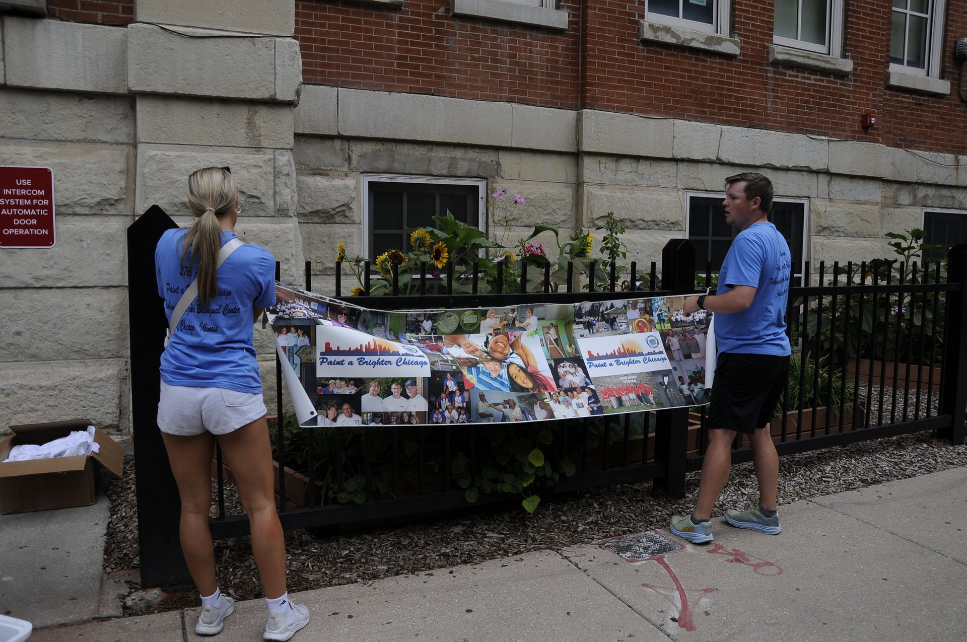 A man and a woman are standing next to a sign that says no trespassing