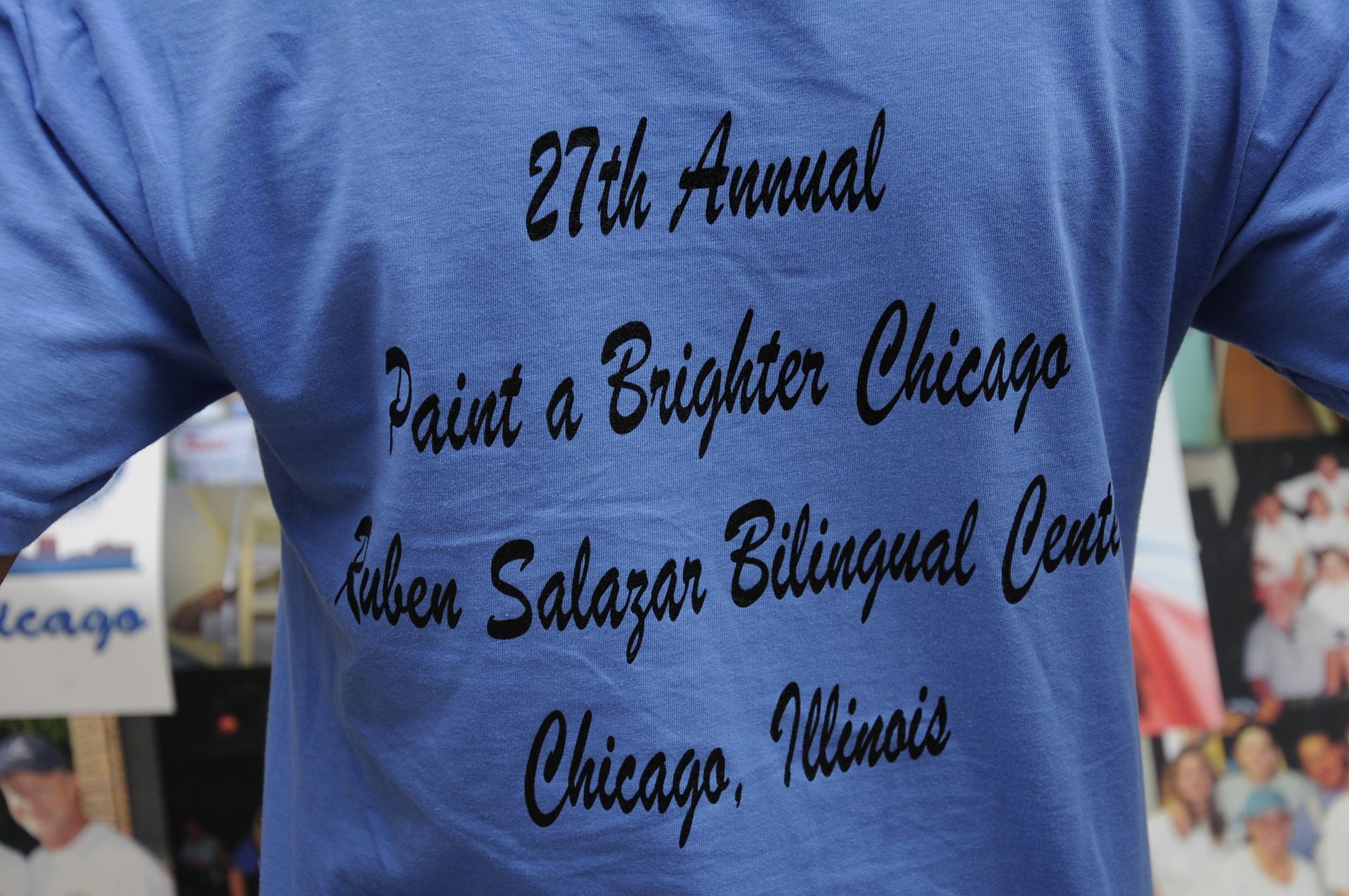 A person is wearing a shirt that says 27th annual paint a brighter chicago