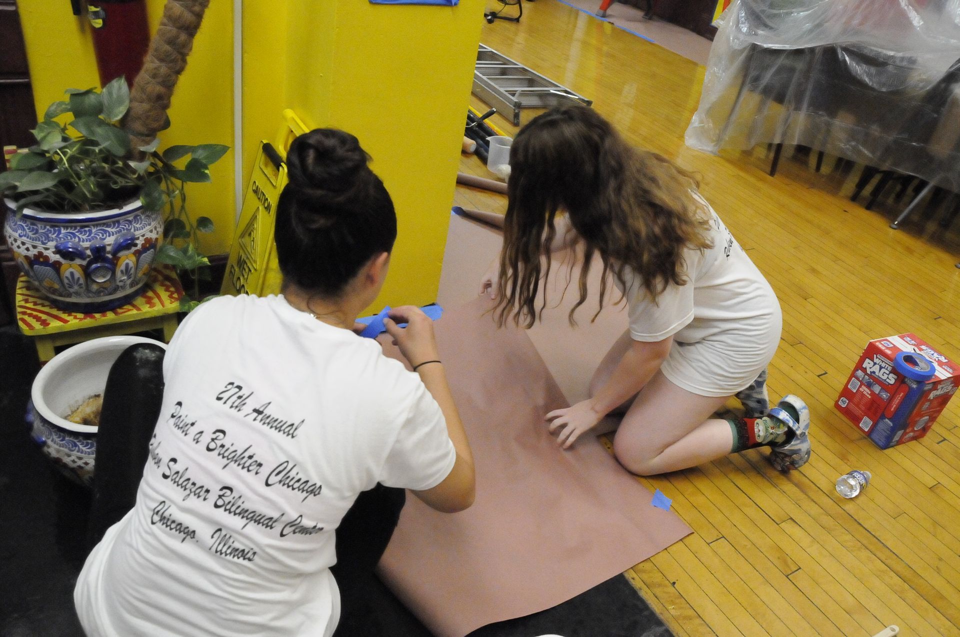 A woman wearing a white shirt that says 25th annual