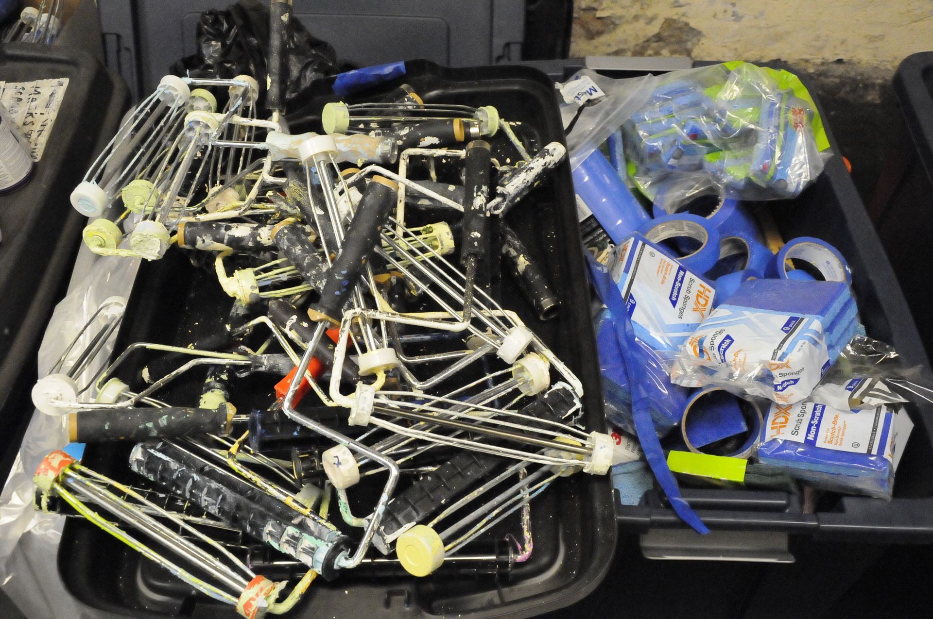 A bunch of wires in a container with a bag of kleenex