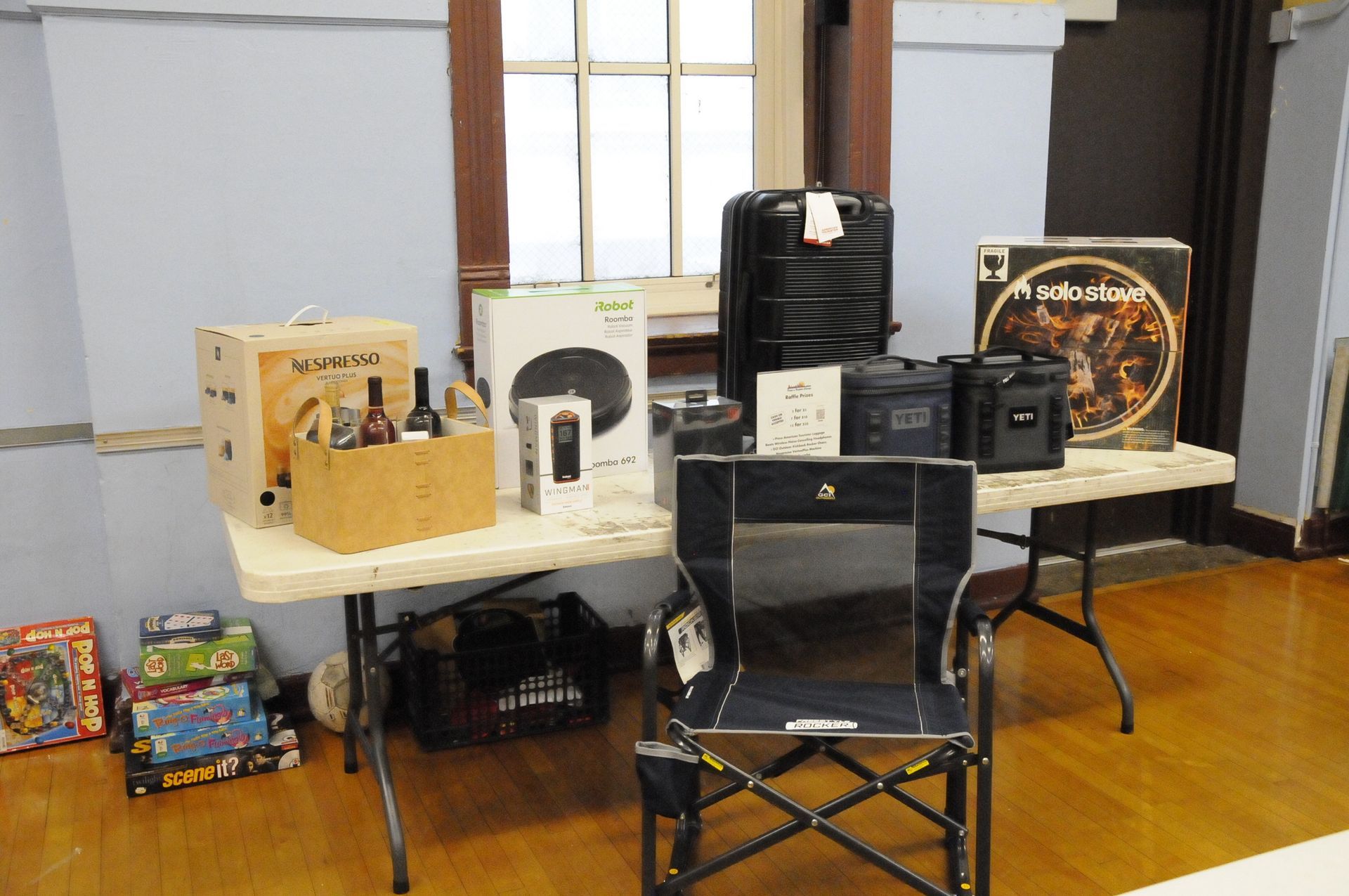 A chair is sitting in front of a table with boxes on it.
