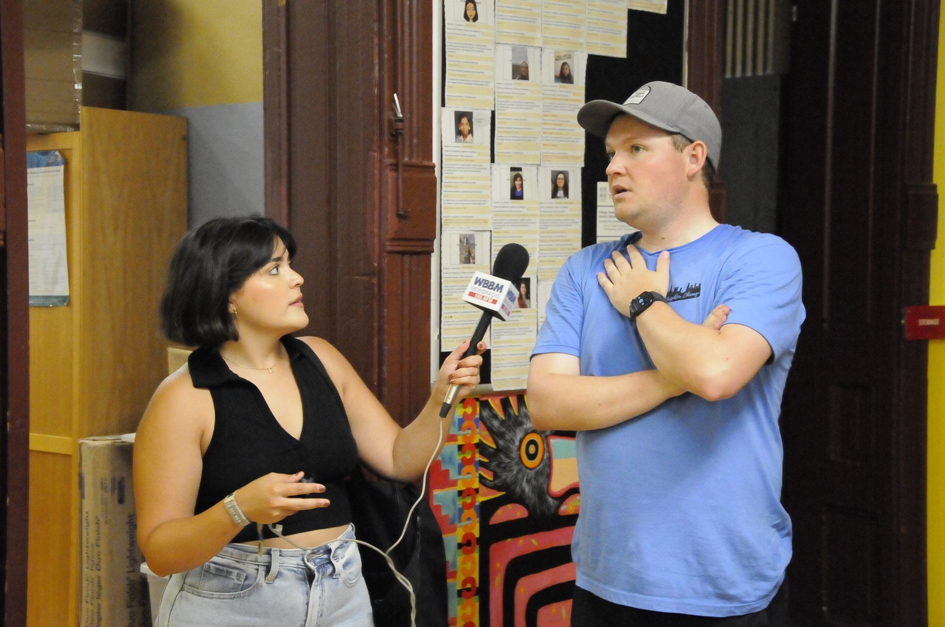 A woman is talking to a man with a microphone