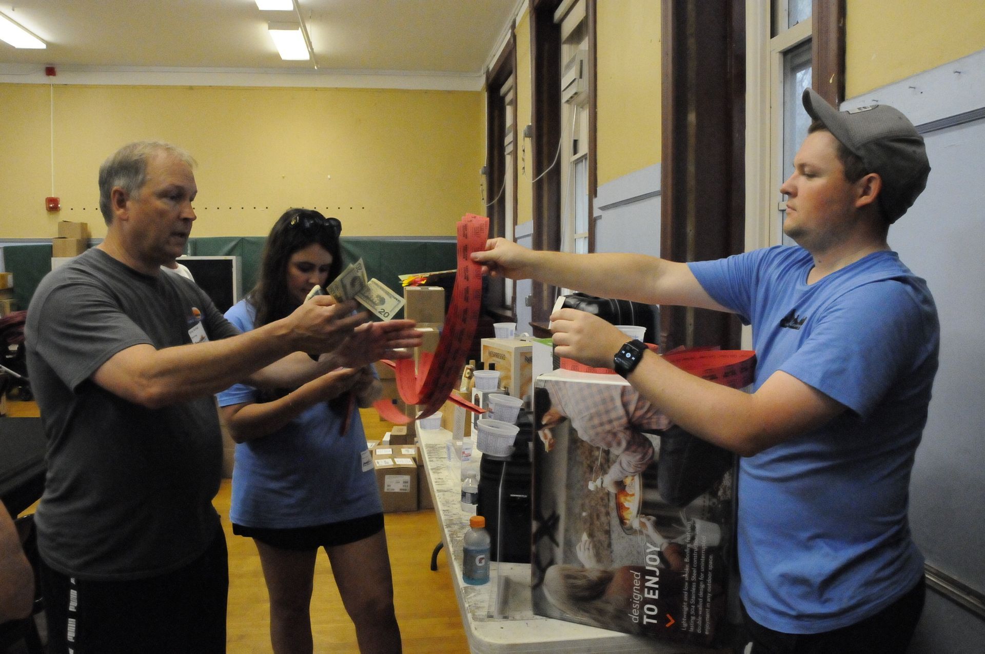A man in a blue shirt is pointing at something