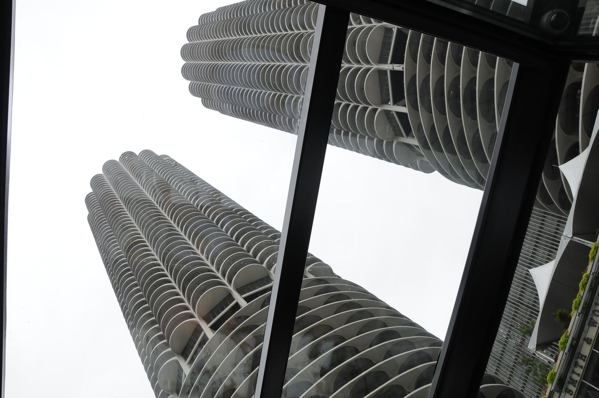 Looking up at a tall building through a window