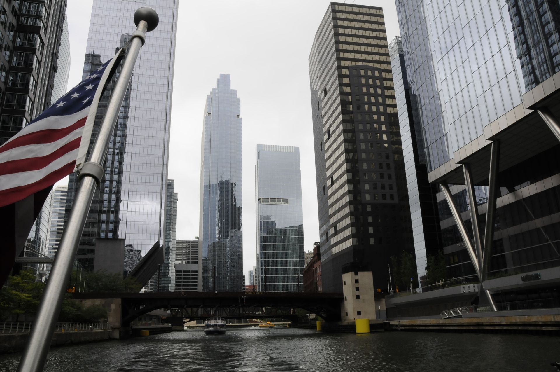 An american flag is flying in front of a city skyline