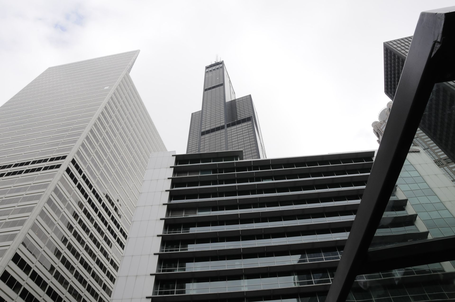 Looking up at a tall building with a cloudy sky in the background
