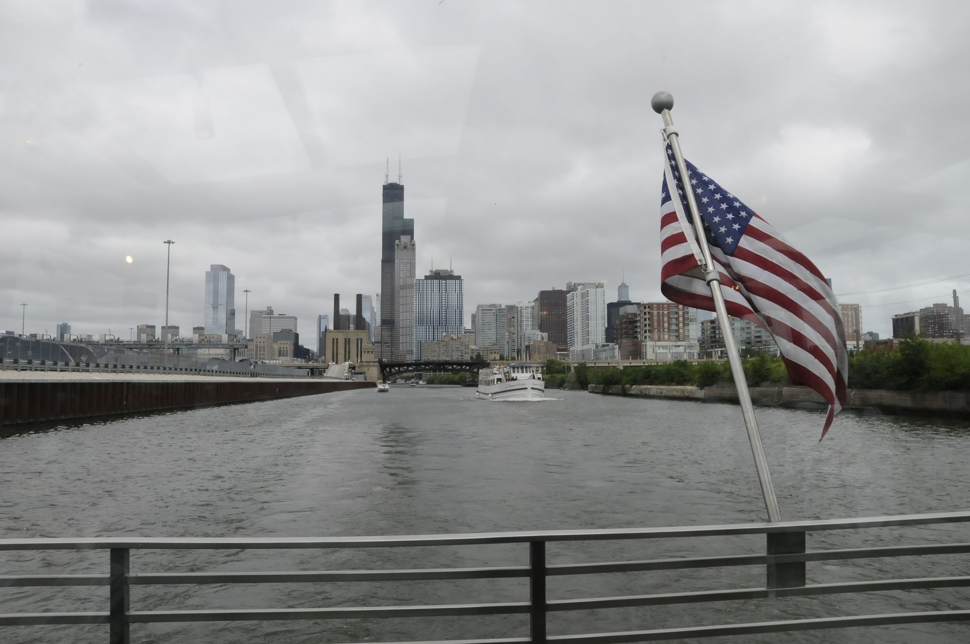 An american flag is flying in front of a city skyline