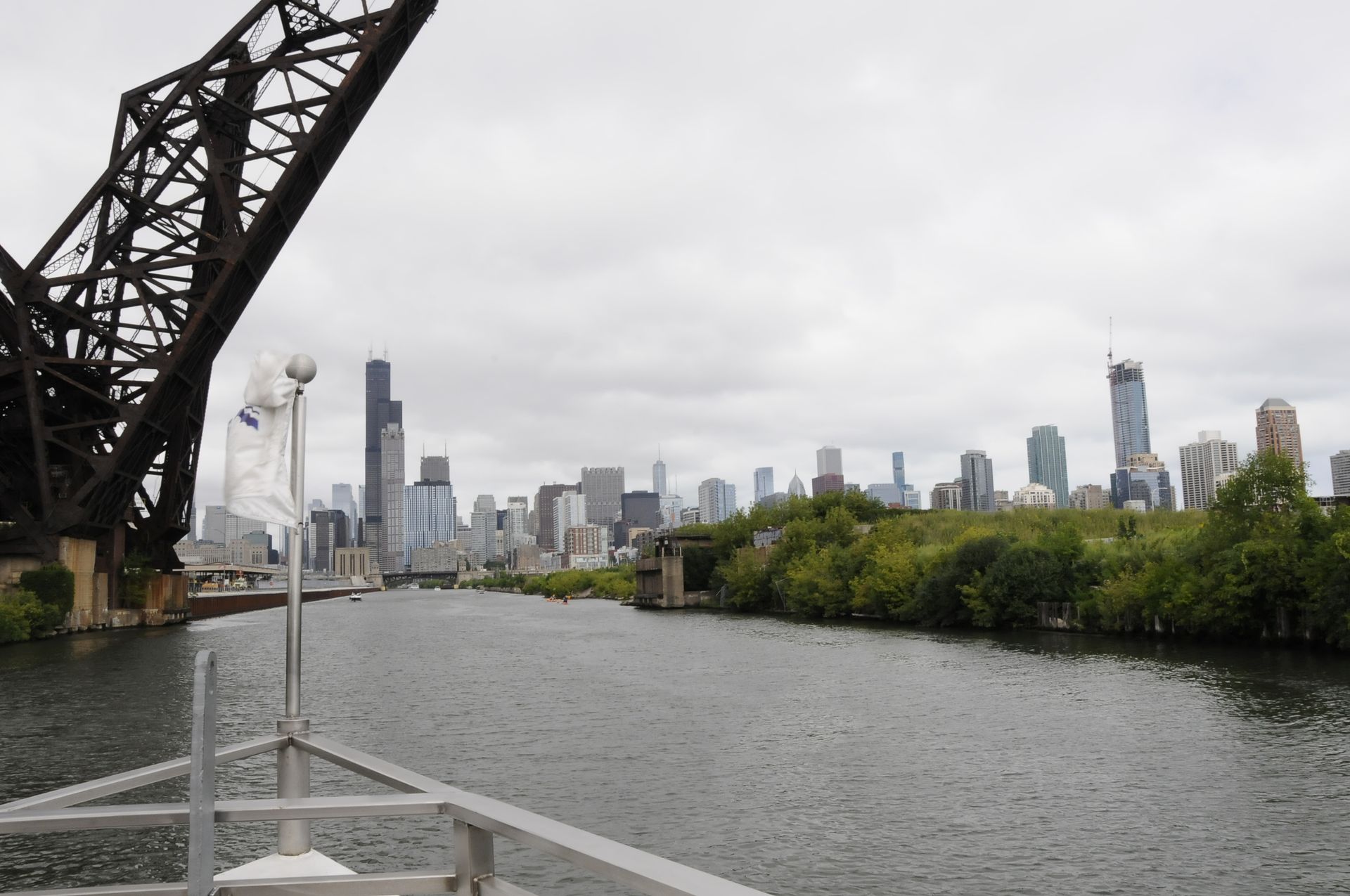 A bridge over a body of water with a city skyline in the background