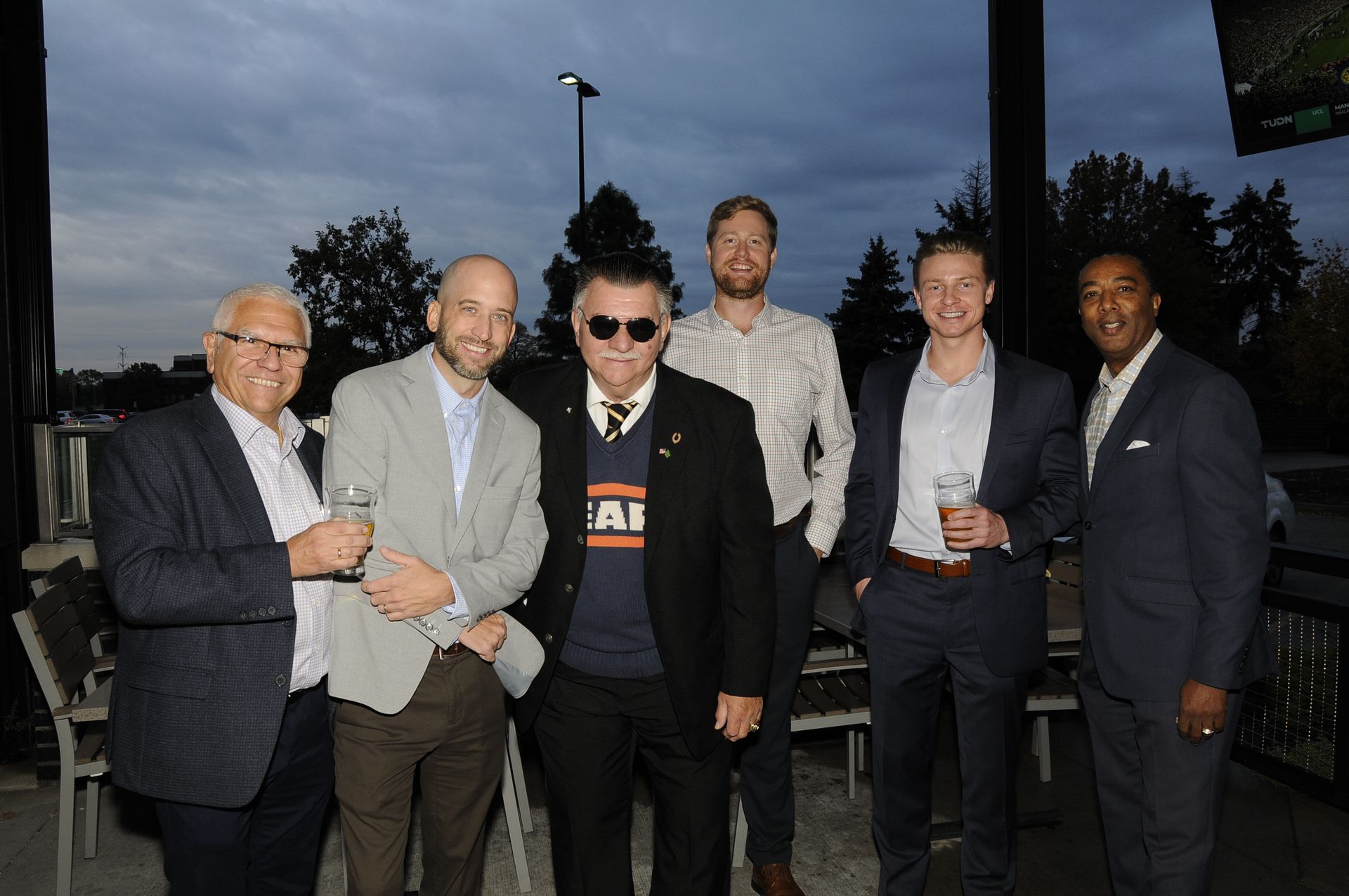 A group of men in suits are posing for a picture.