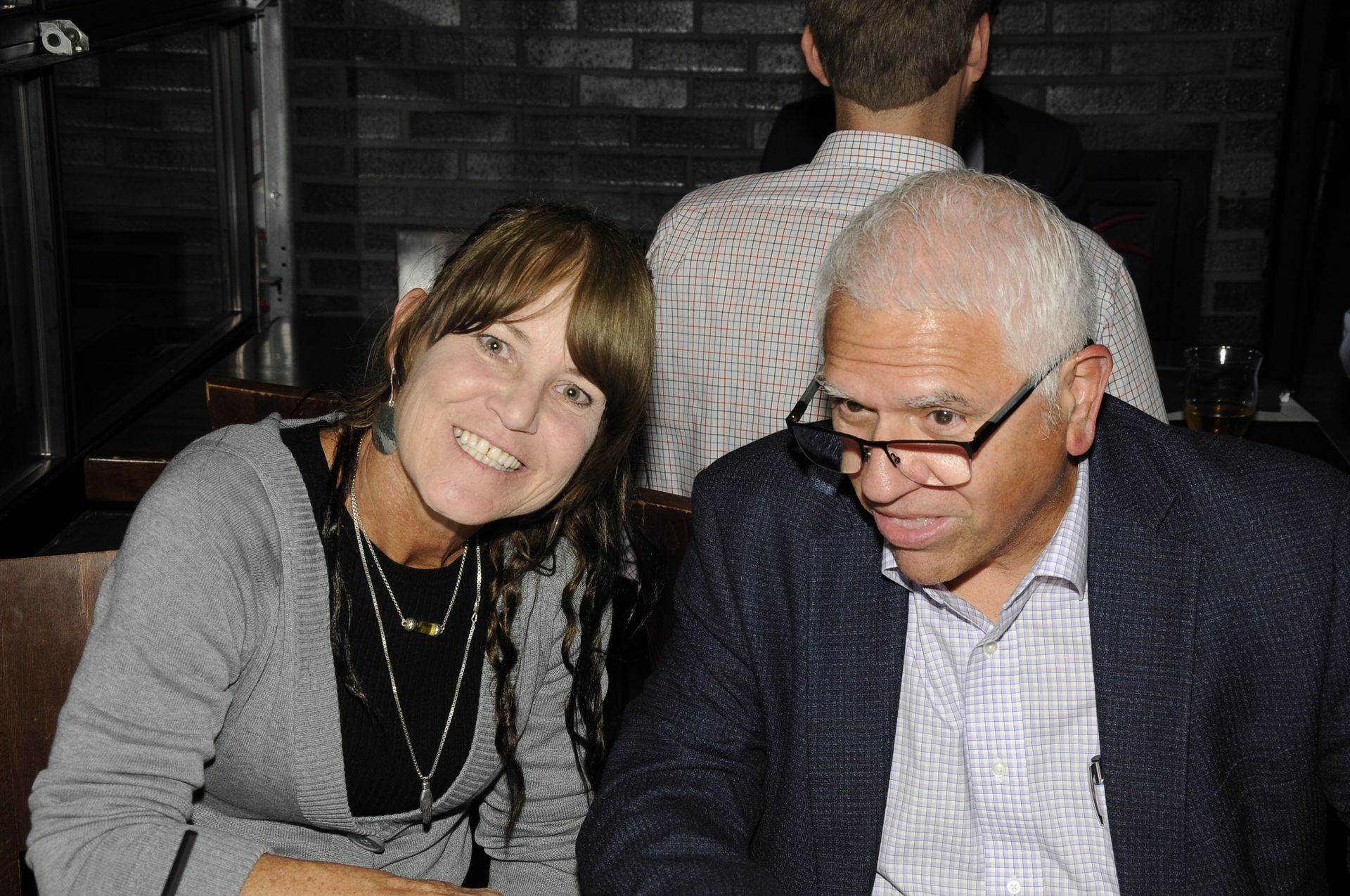 A man and a woman are sitting next to each other and smiling