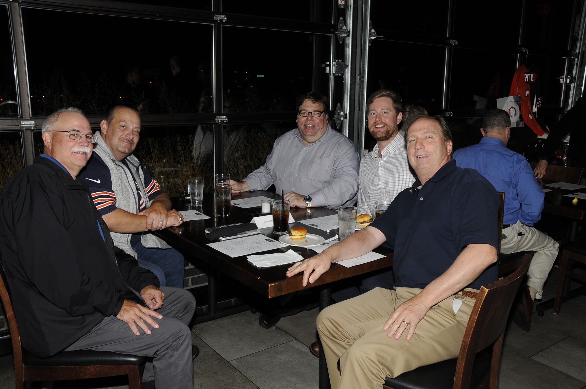 A group of men are sitting at a table in a restaurant
