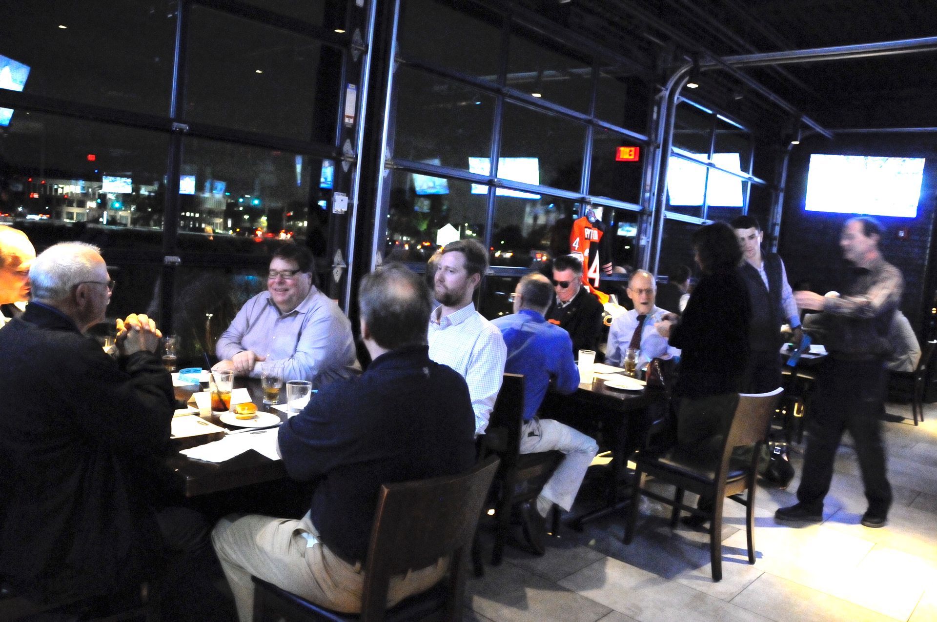 A group of people are sitting at tables in a restaurant