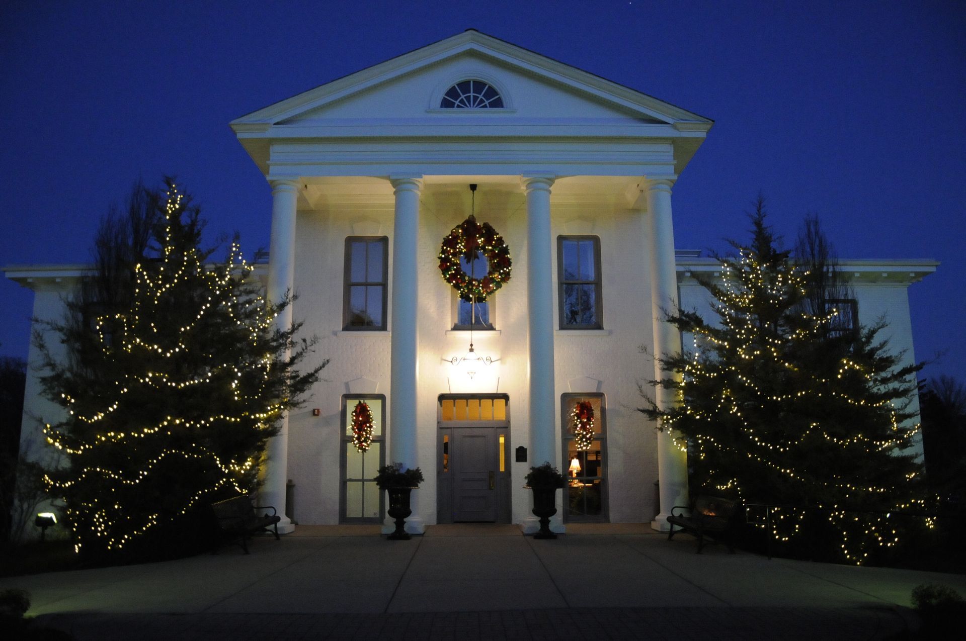A large white house with christmas lights on it