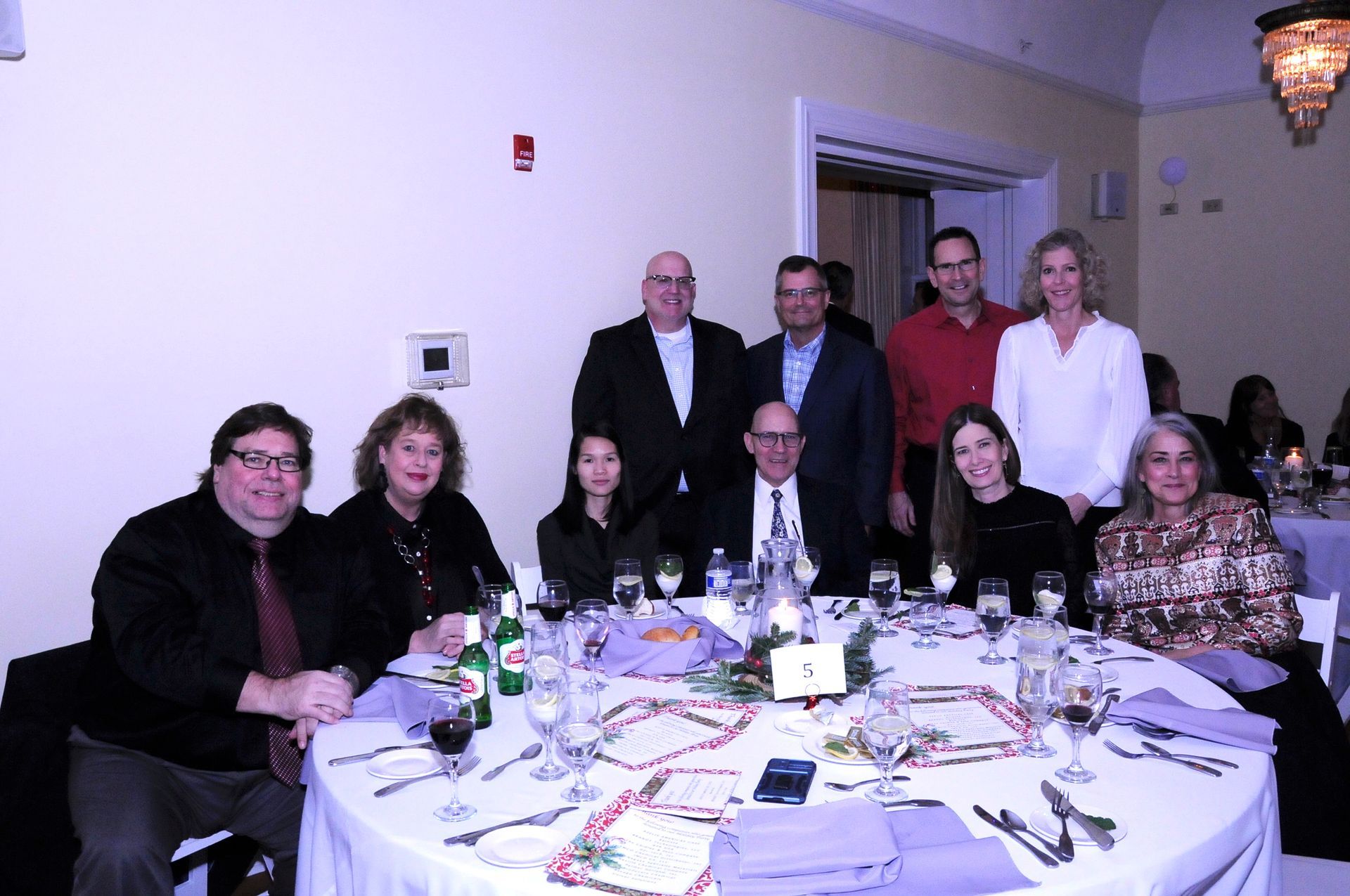 A group of people sitting around a table with wine glasses