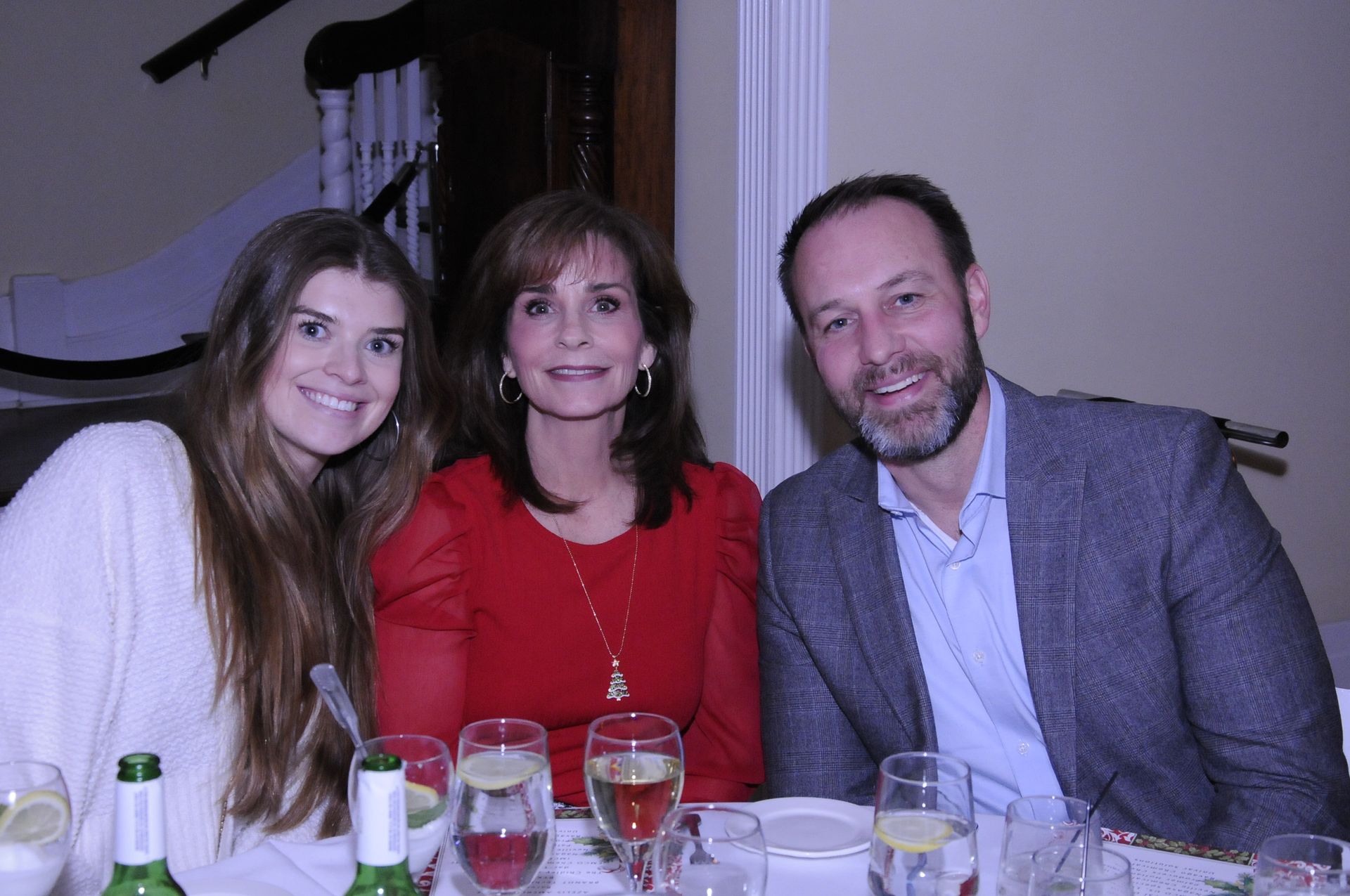 A group of people are sitting at a table with glasses of wine.