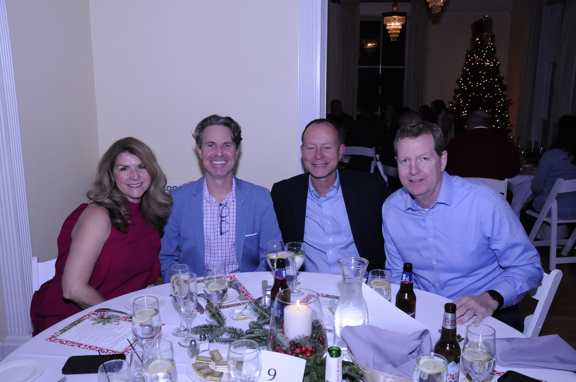 A group of people are posing for a picture at a table.