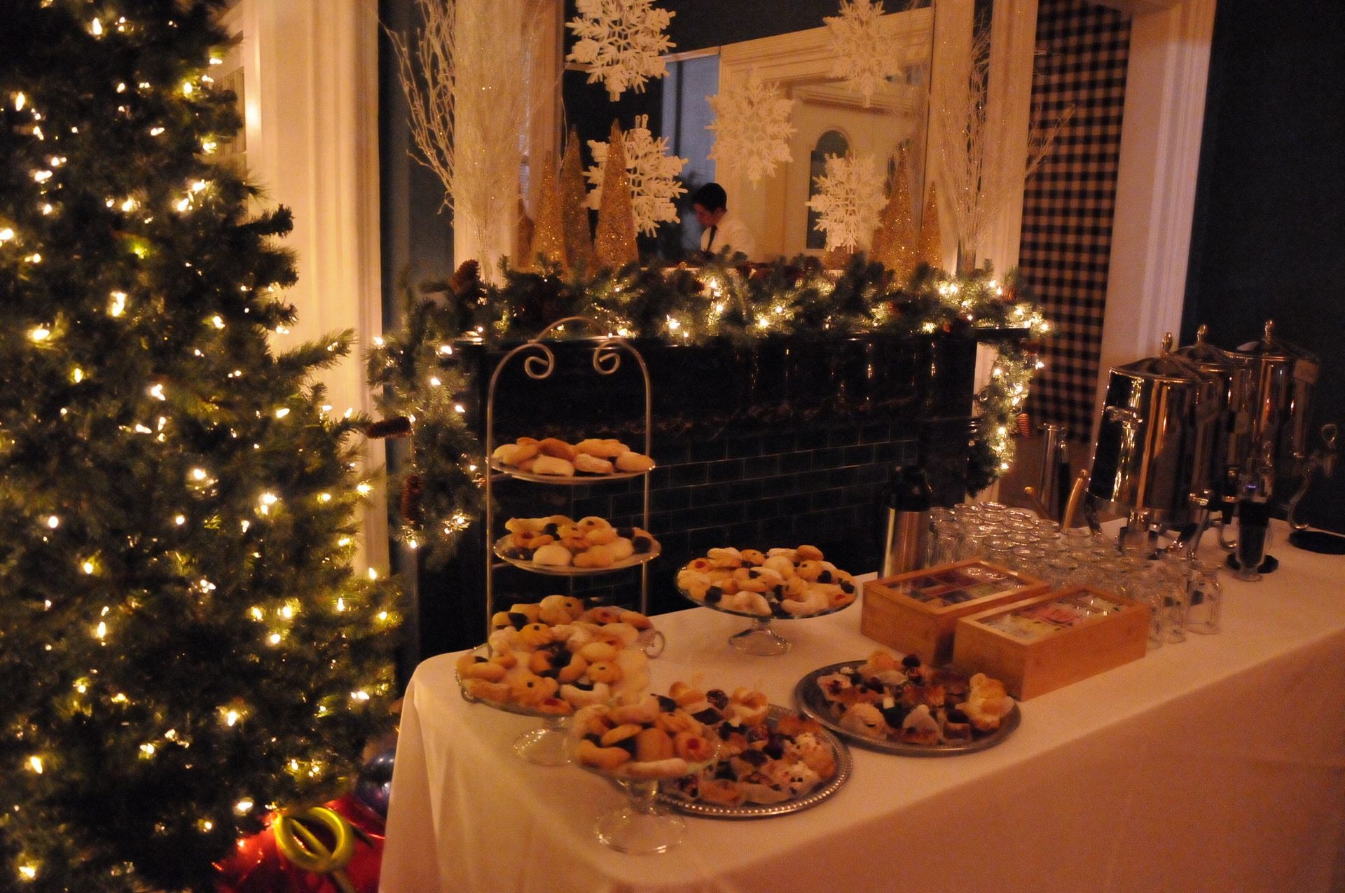 A buffet table with a christmas tree in the background