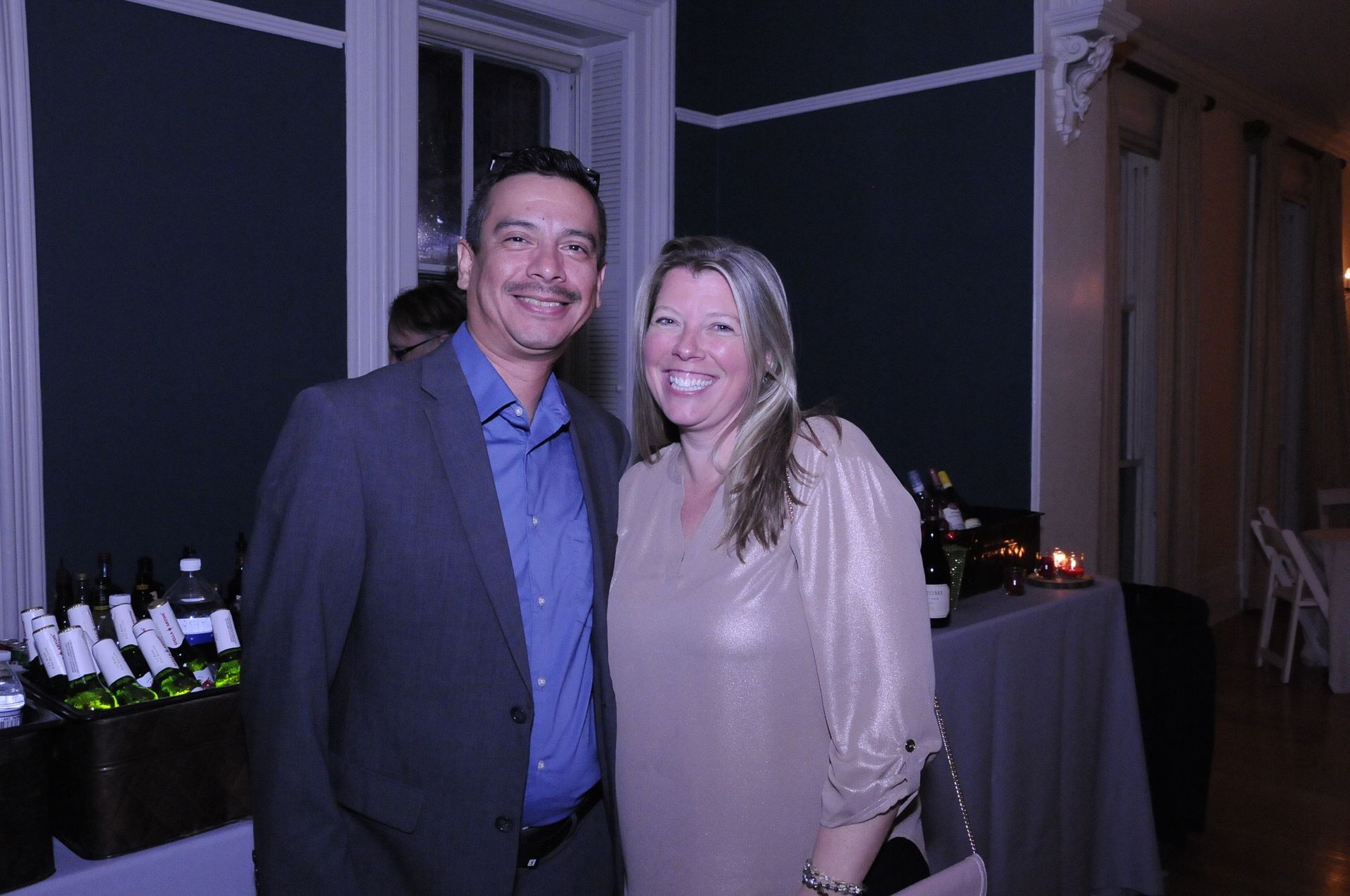 A man and a woman are posing for a picture in a room.