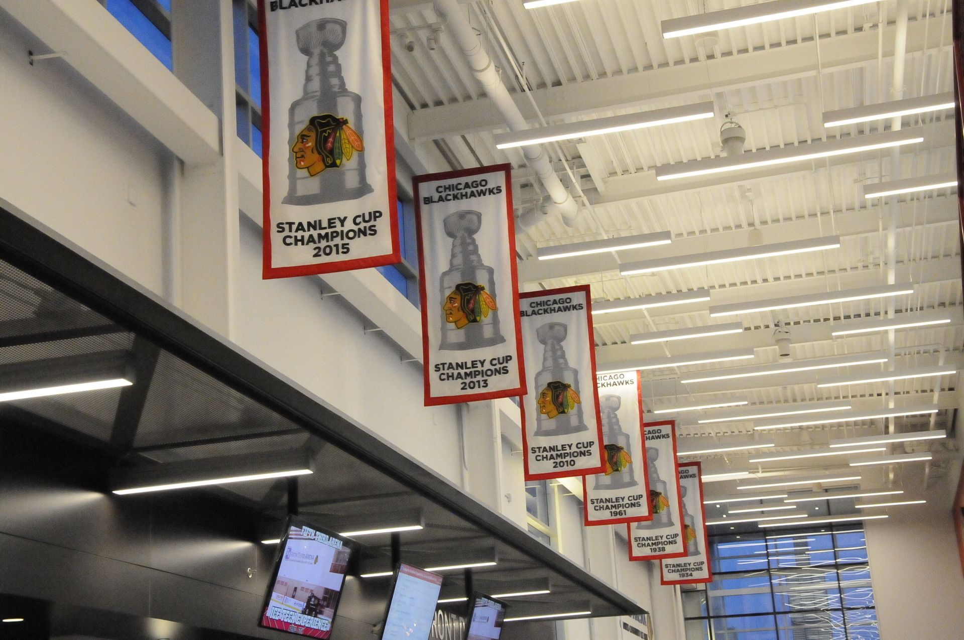 A row of banners hanging from the ceiling that say stanley cup champions 2015