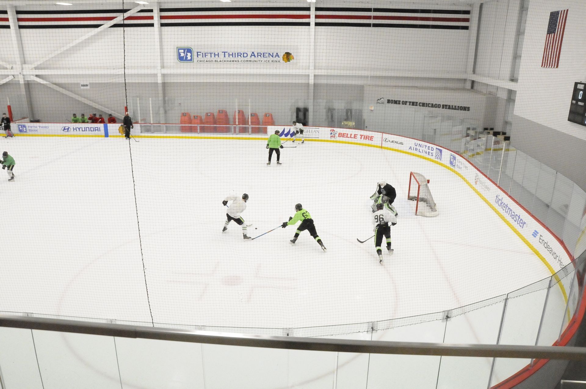 A group of people are playing ice hockey on a rink