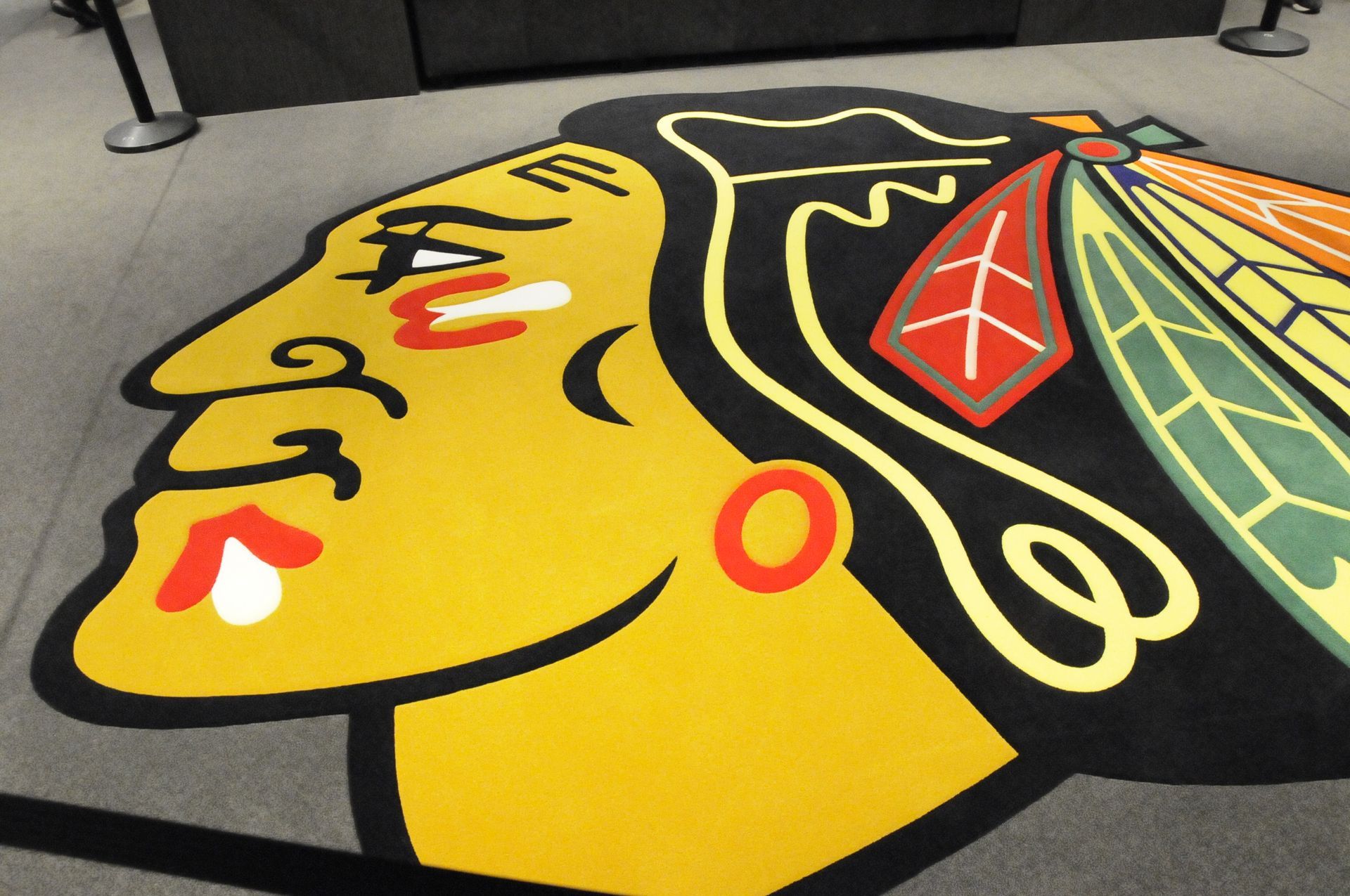 A blackhawks logo is painted on the floor