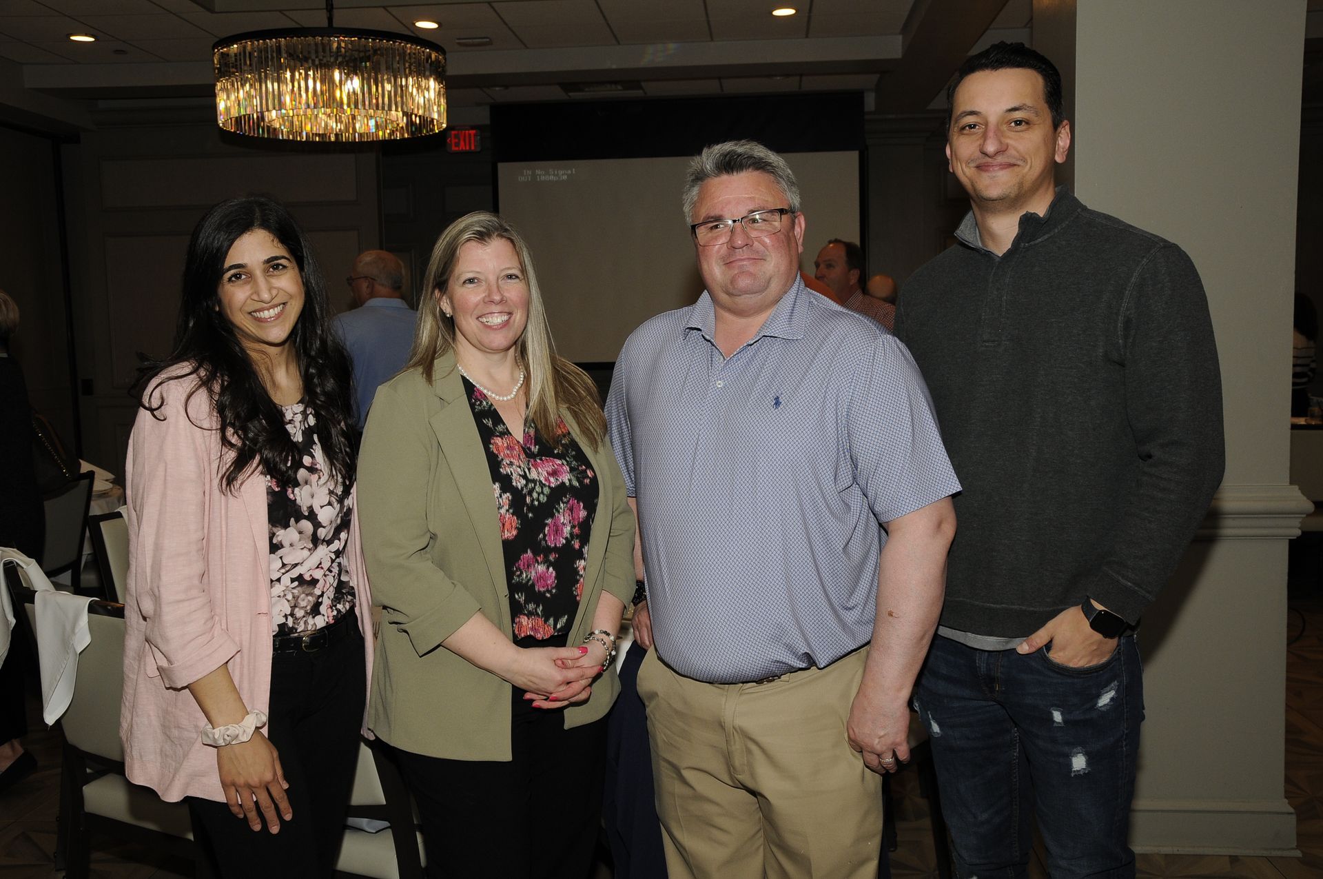 A group of people are posing for a picture in a room.