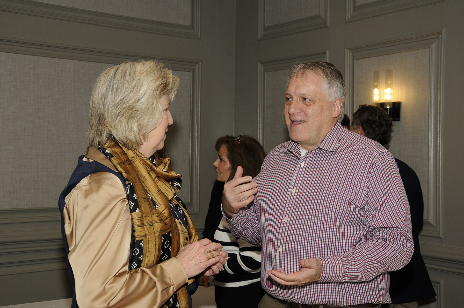 A man and a woman are talking to each other in a room.