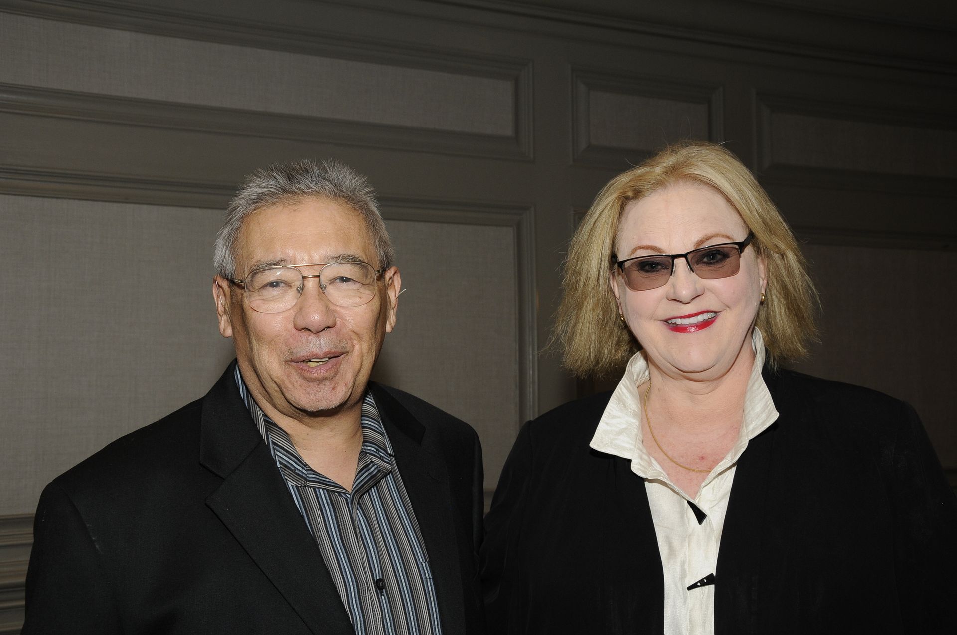 A man and a woman are posing for a picture together.